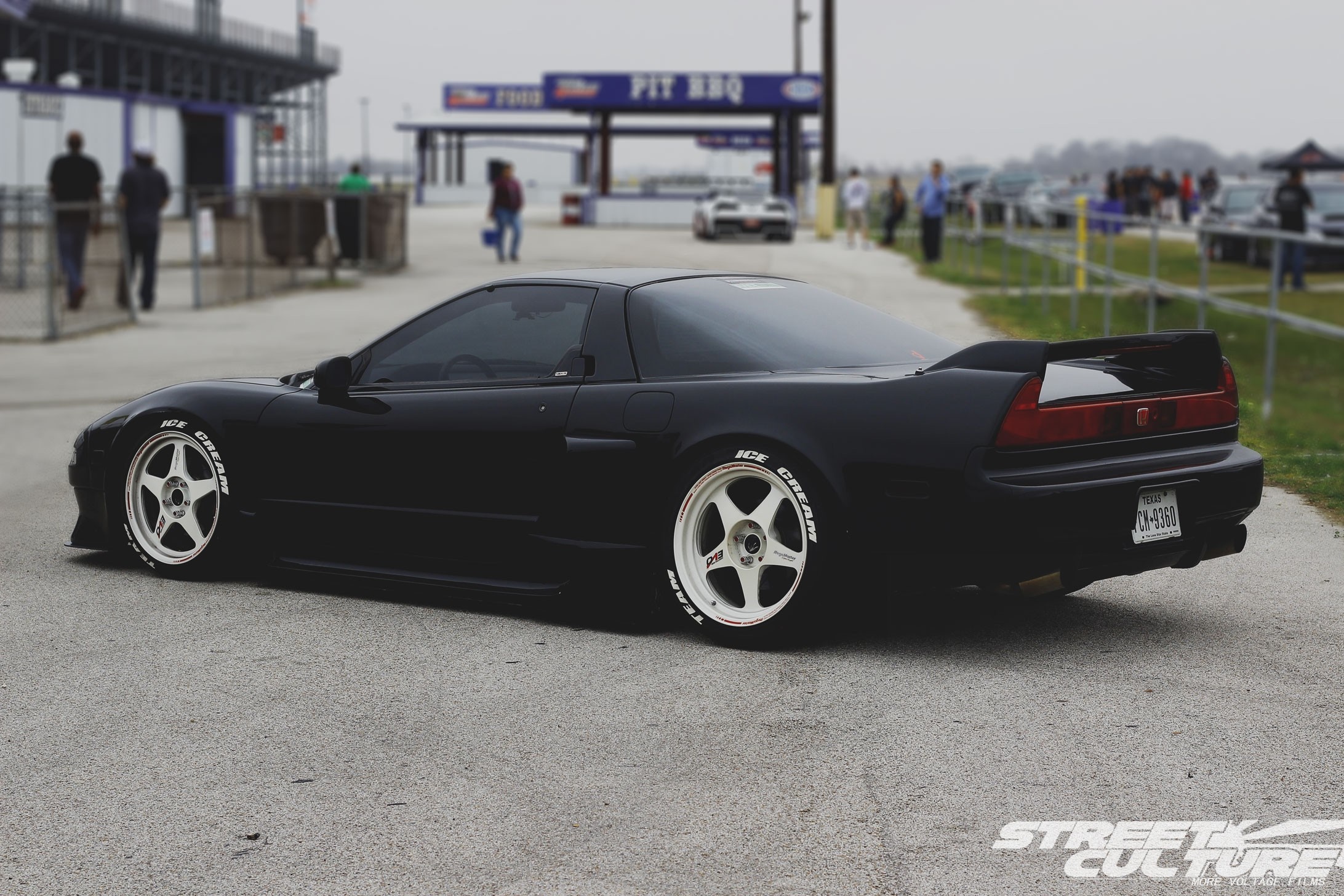 Black Honda NSX with white wheels at a race track HD Wallpaper