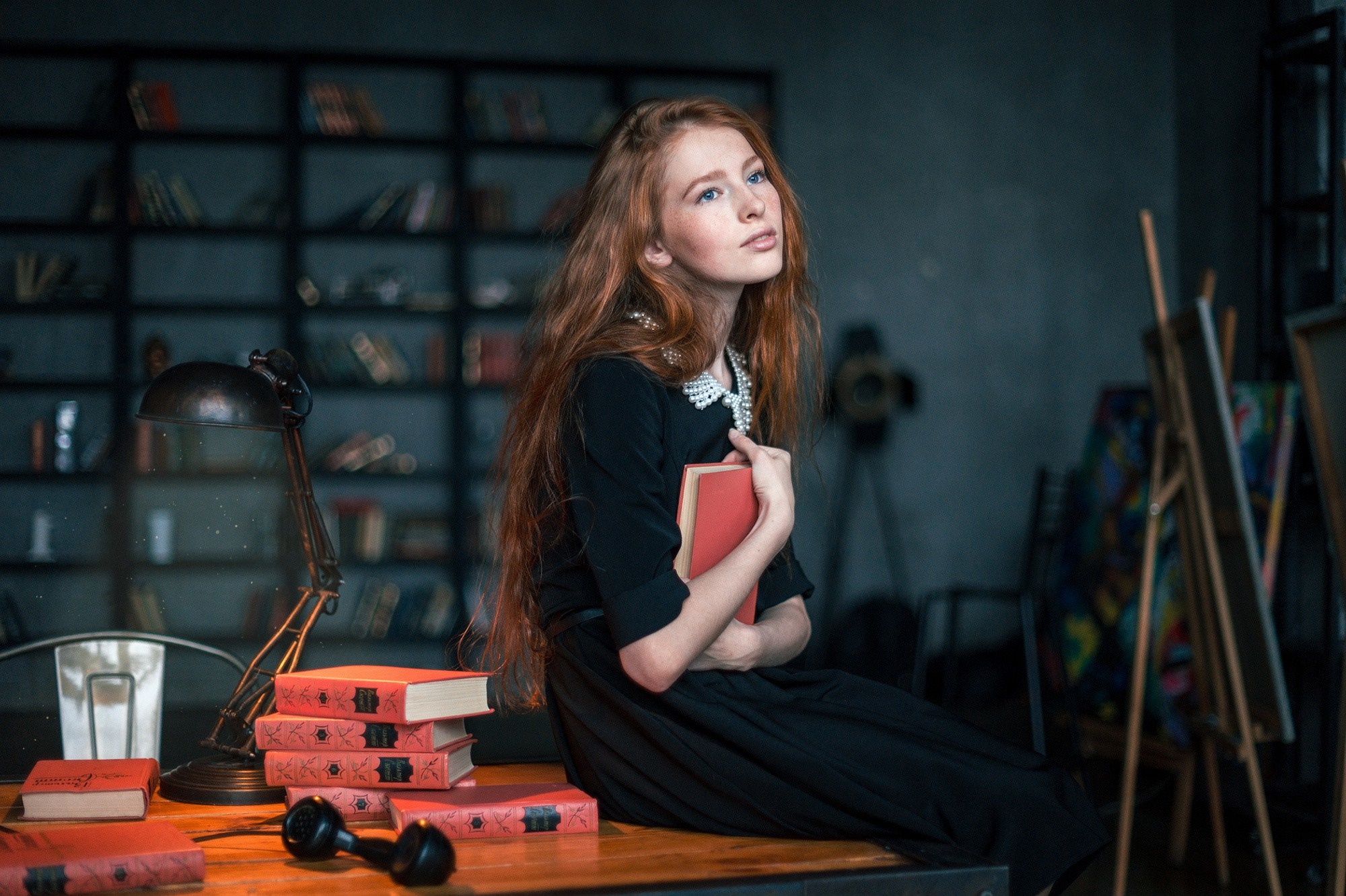 Redhead woman in black dress holding a book HD Wallpaper