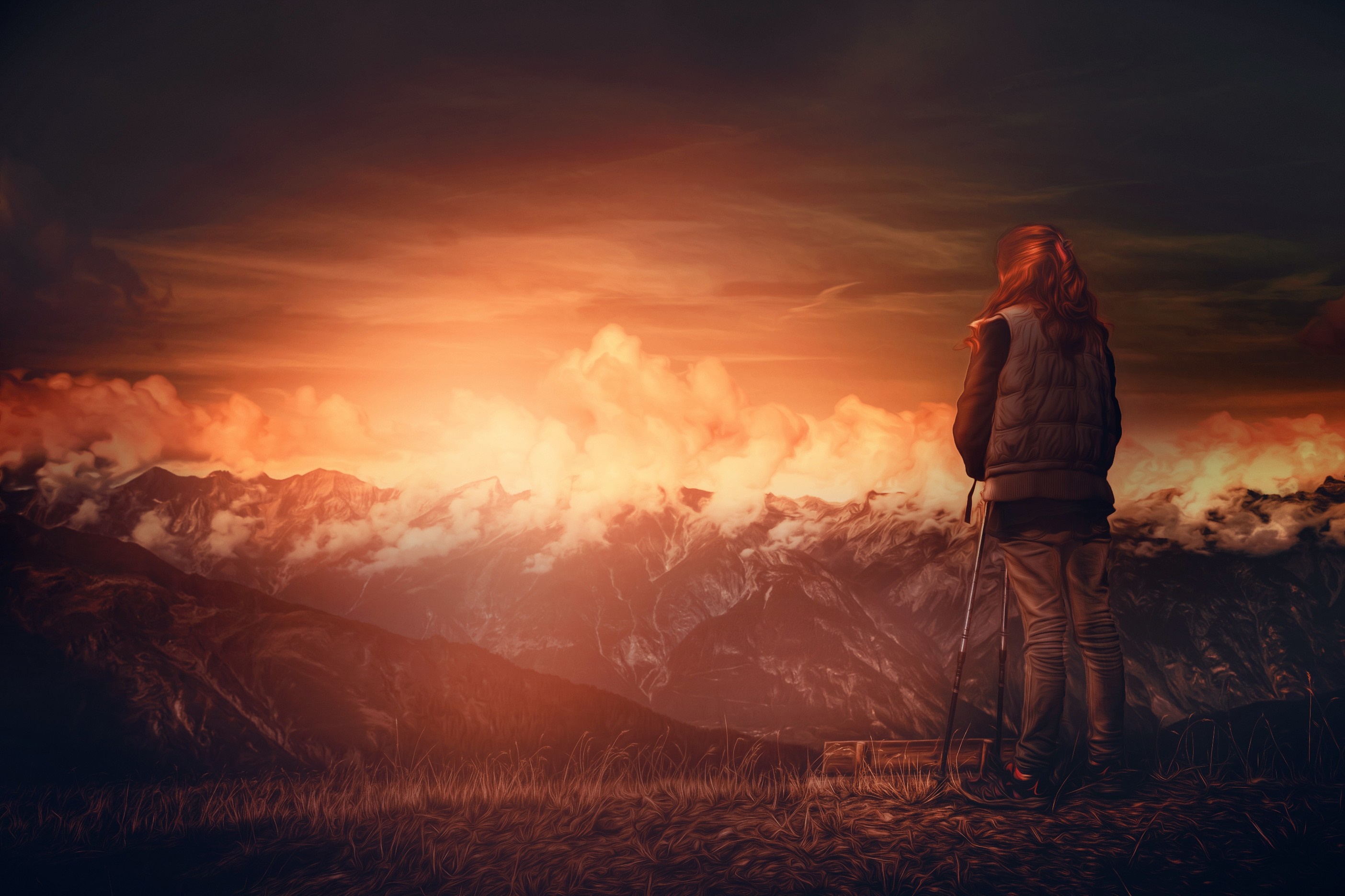 Woman with hiking poles overlooking mountains at sunset HD Wallpaper