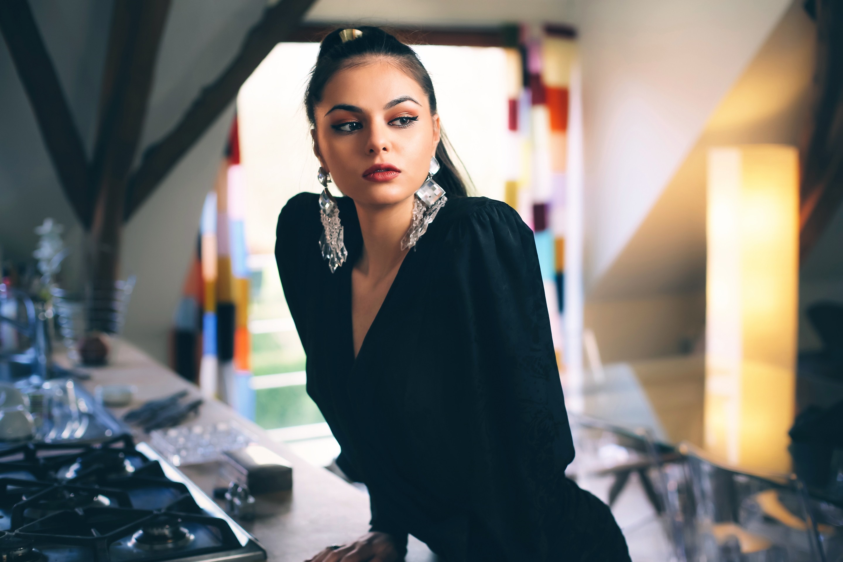 Woman with large earrings in black dress HD Wallpaper