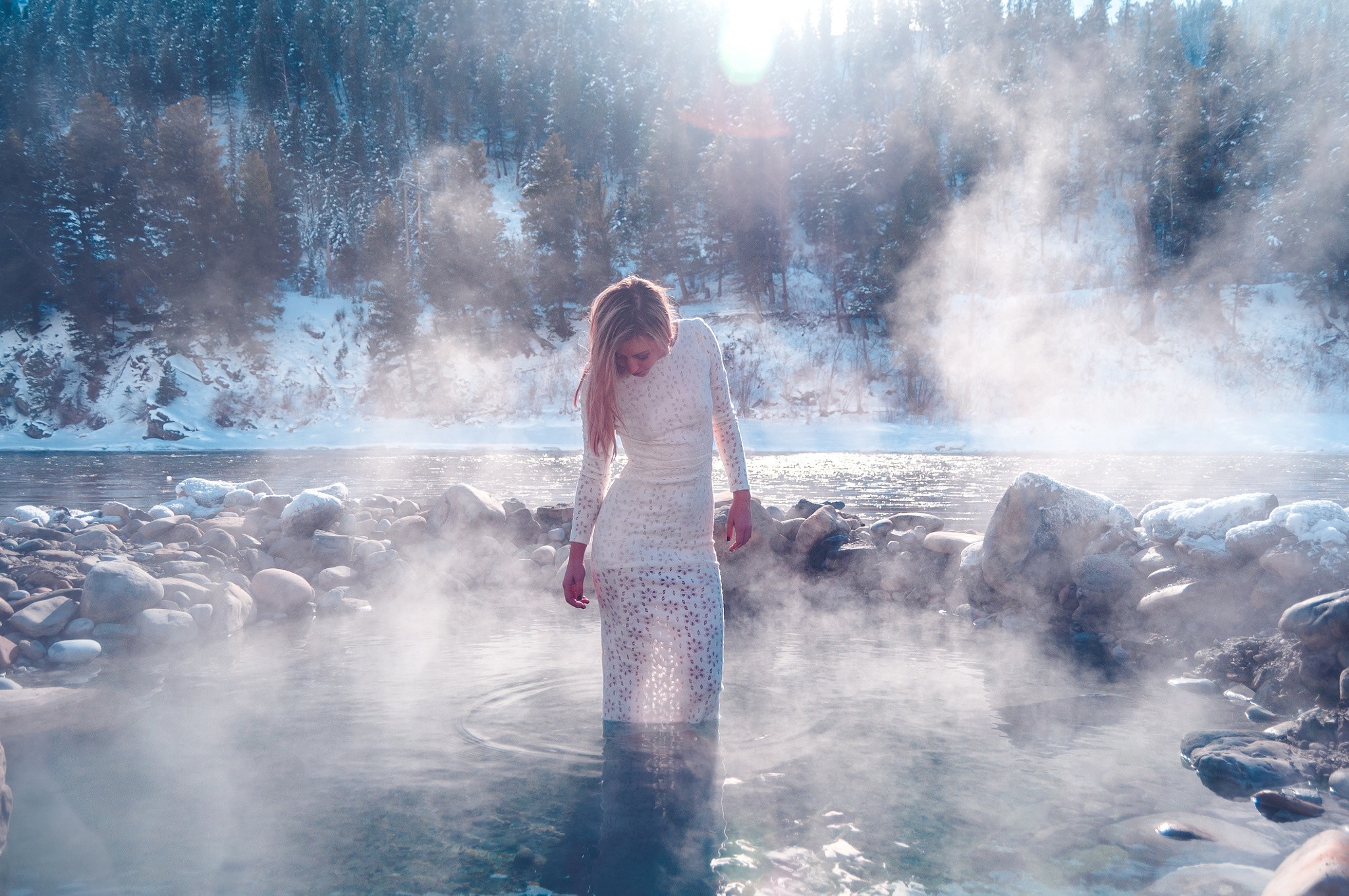 Woman in white dress in steaming hot spring in winter HD Wallpaper