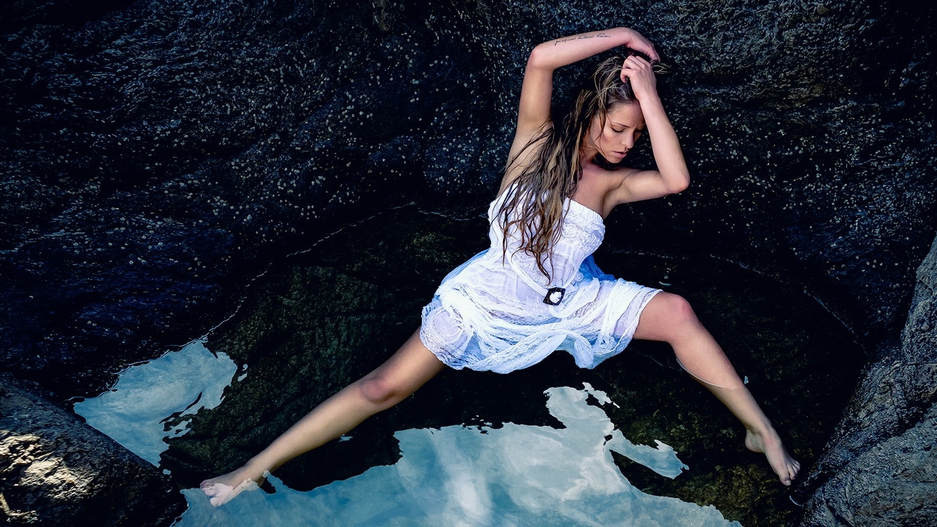 Woman in white dress posing in water among rocks HD Wallpaper