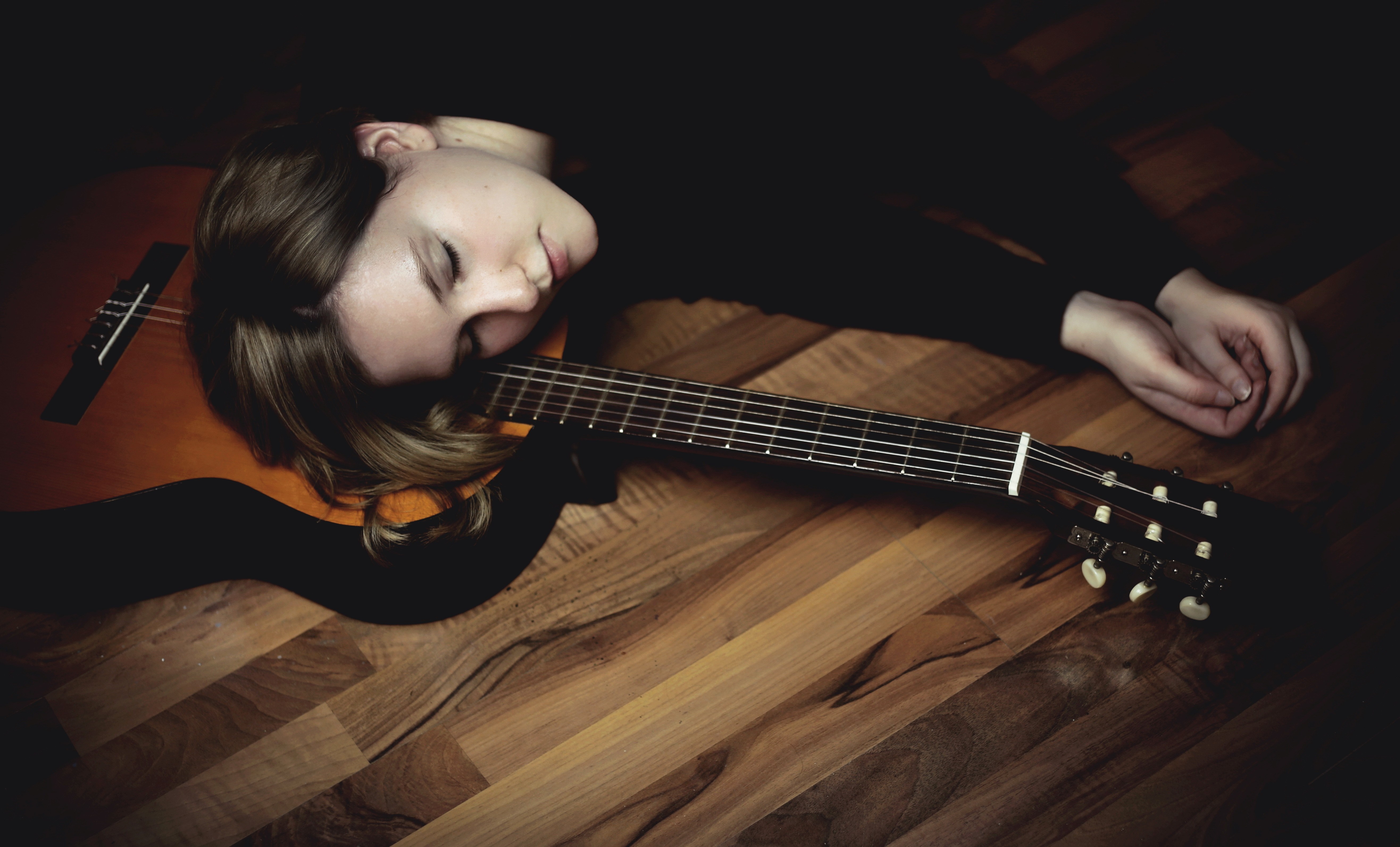 Woman sleeping on a guitar on the floor HD Wallpaper