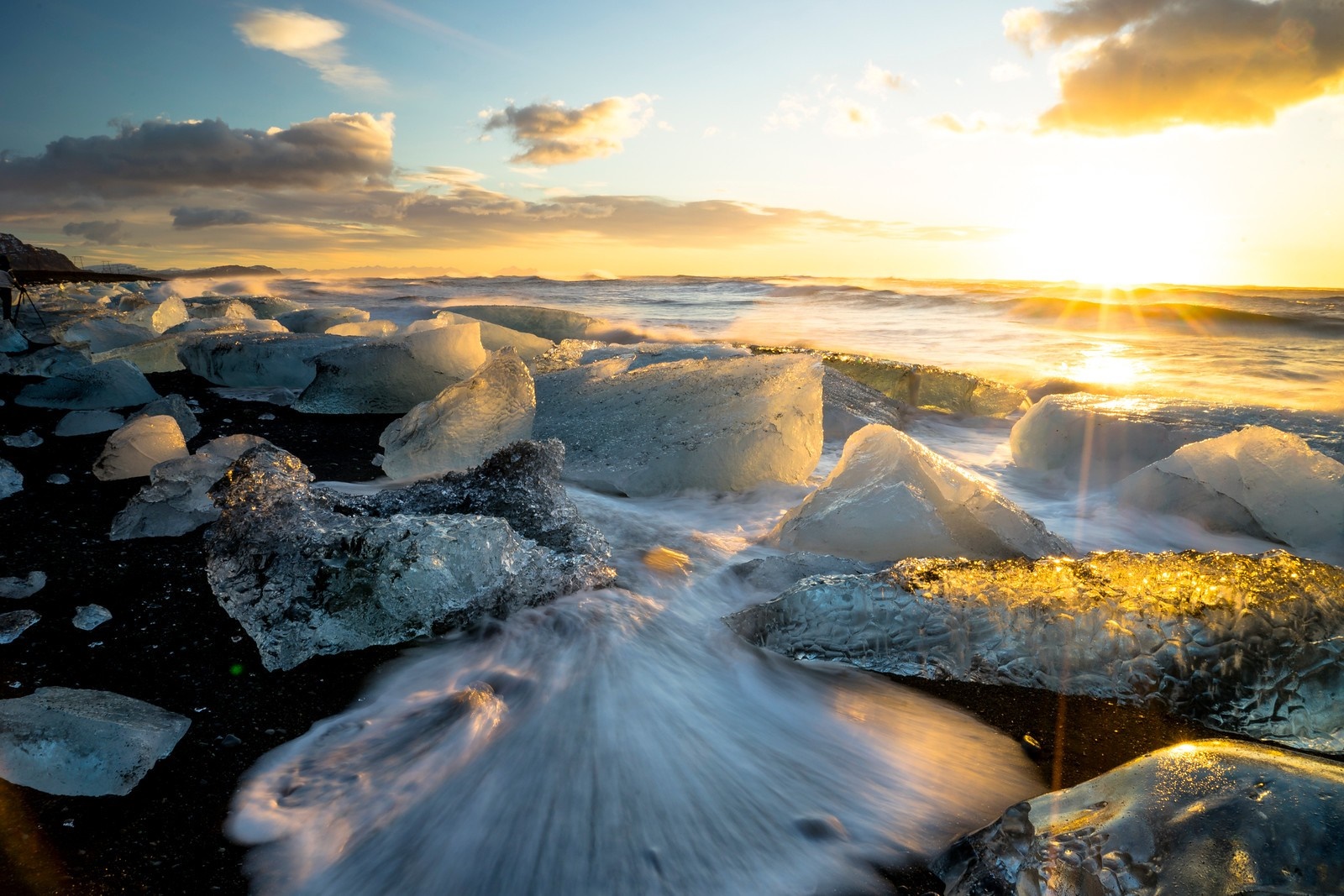 Ice chunks on a black sand beach at sunset HD Wallpaper