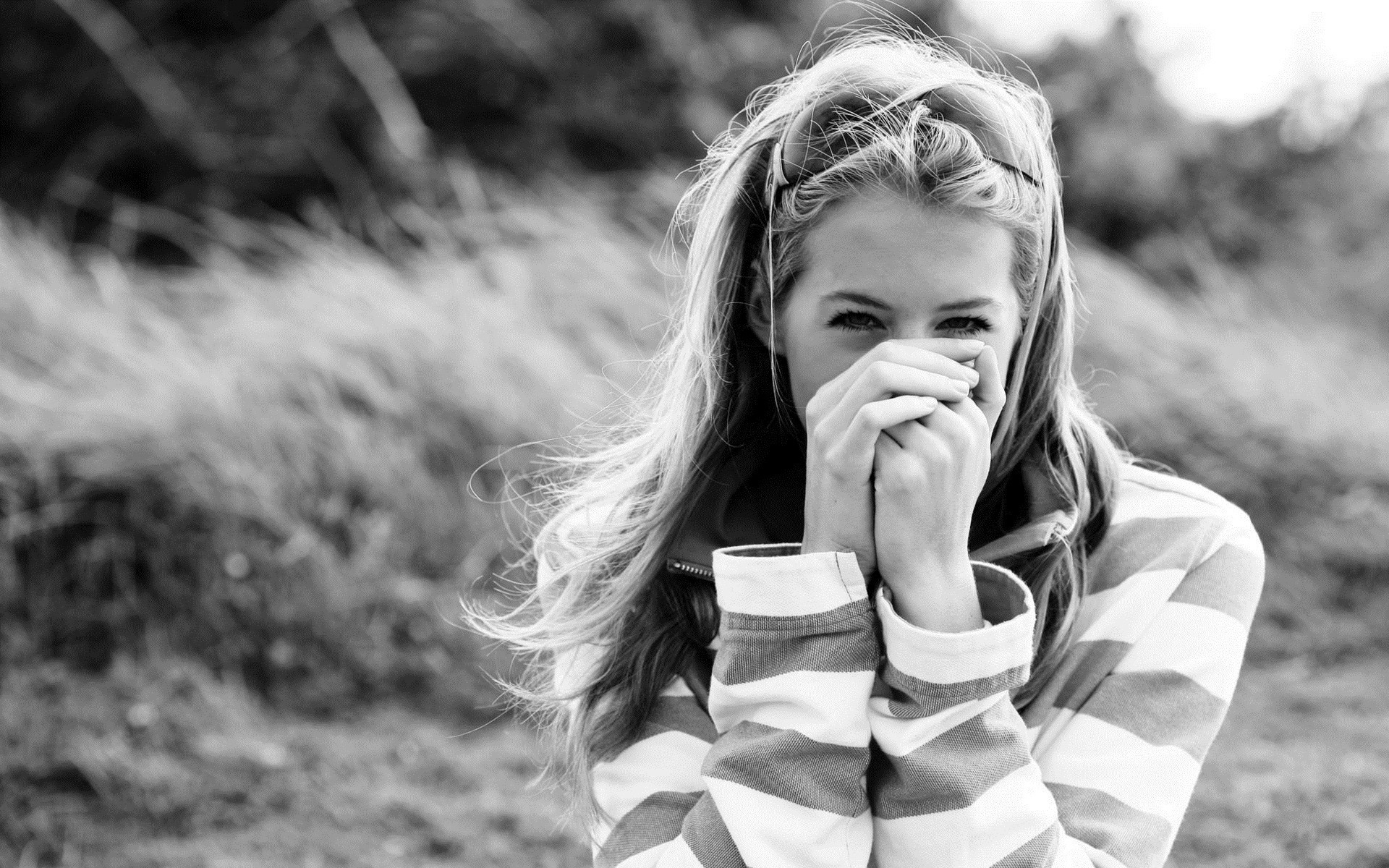 Monochrome portrait of a young woman covering her mouth HD Wallpaper