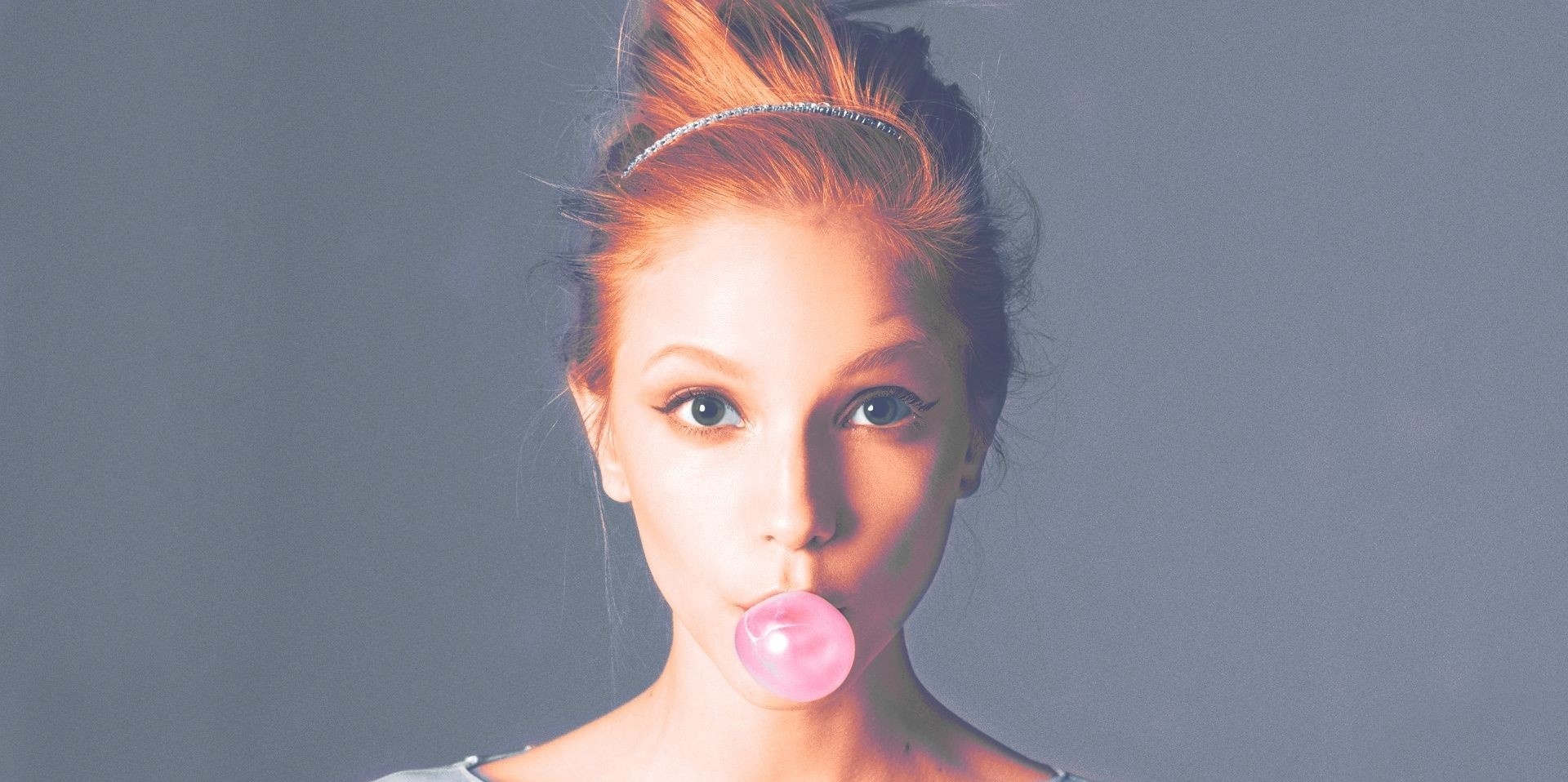Woman with red hair blowing bubblegum HD Wallpaper