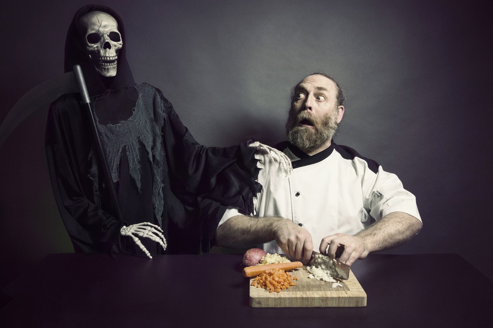 Grim Reaper startling a chef while he chops vegetables HD Wallpaper