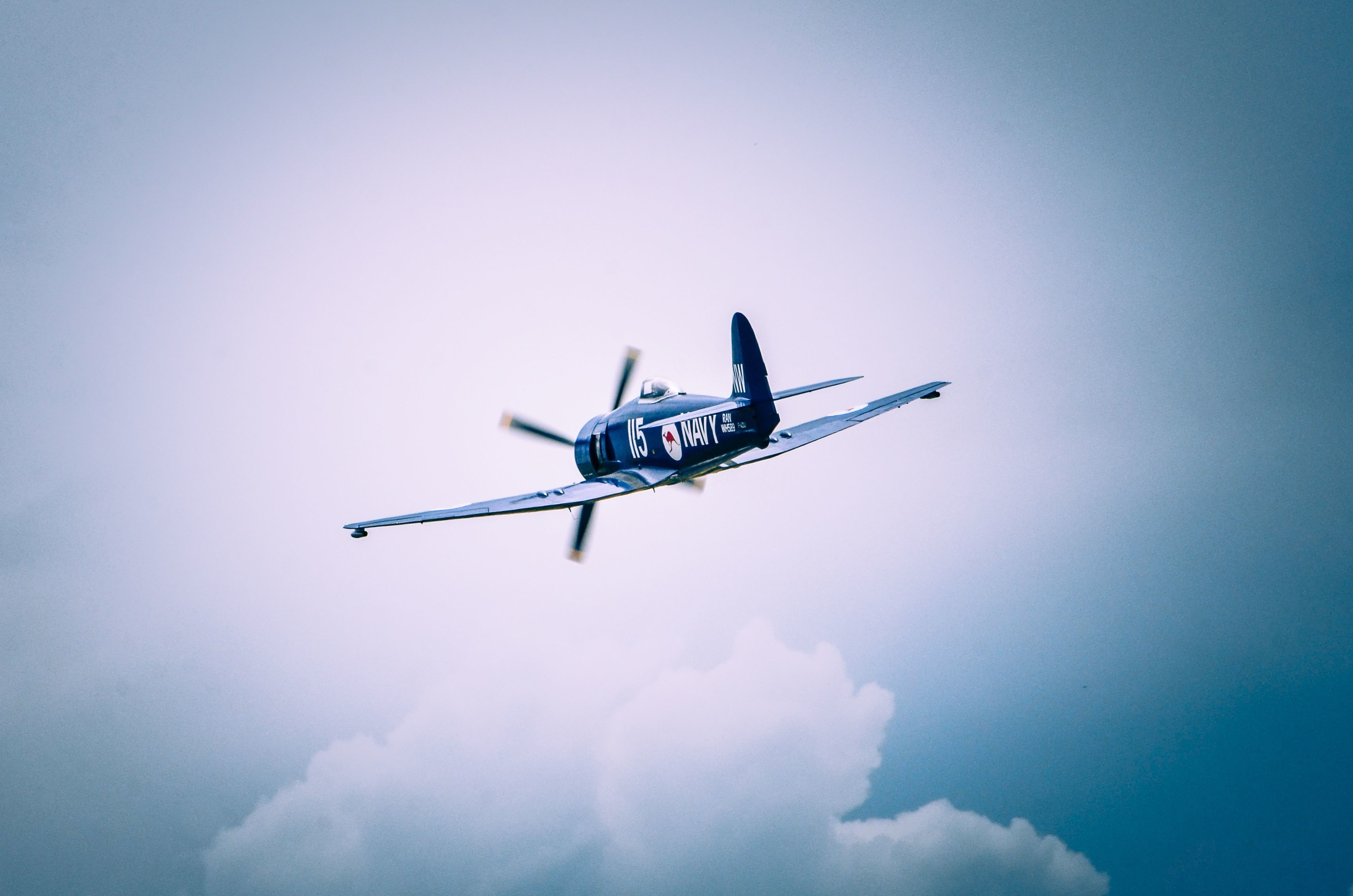 Blue Navy Airplane in Flight HD Wallpaper