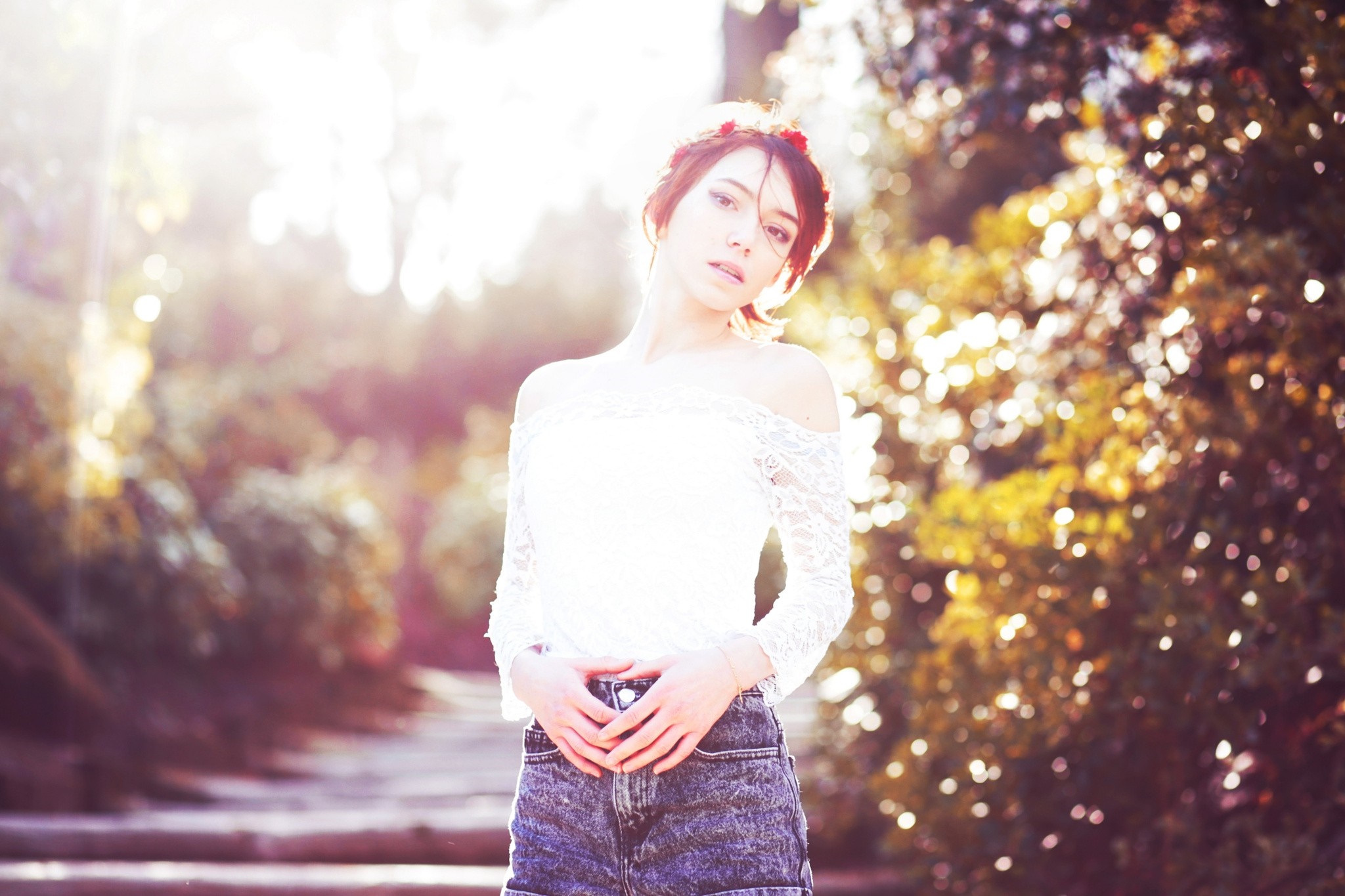 Woman with flower in hair in sunlight HD Wallpaper