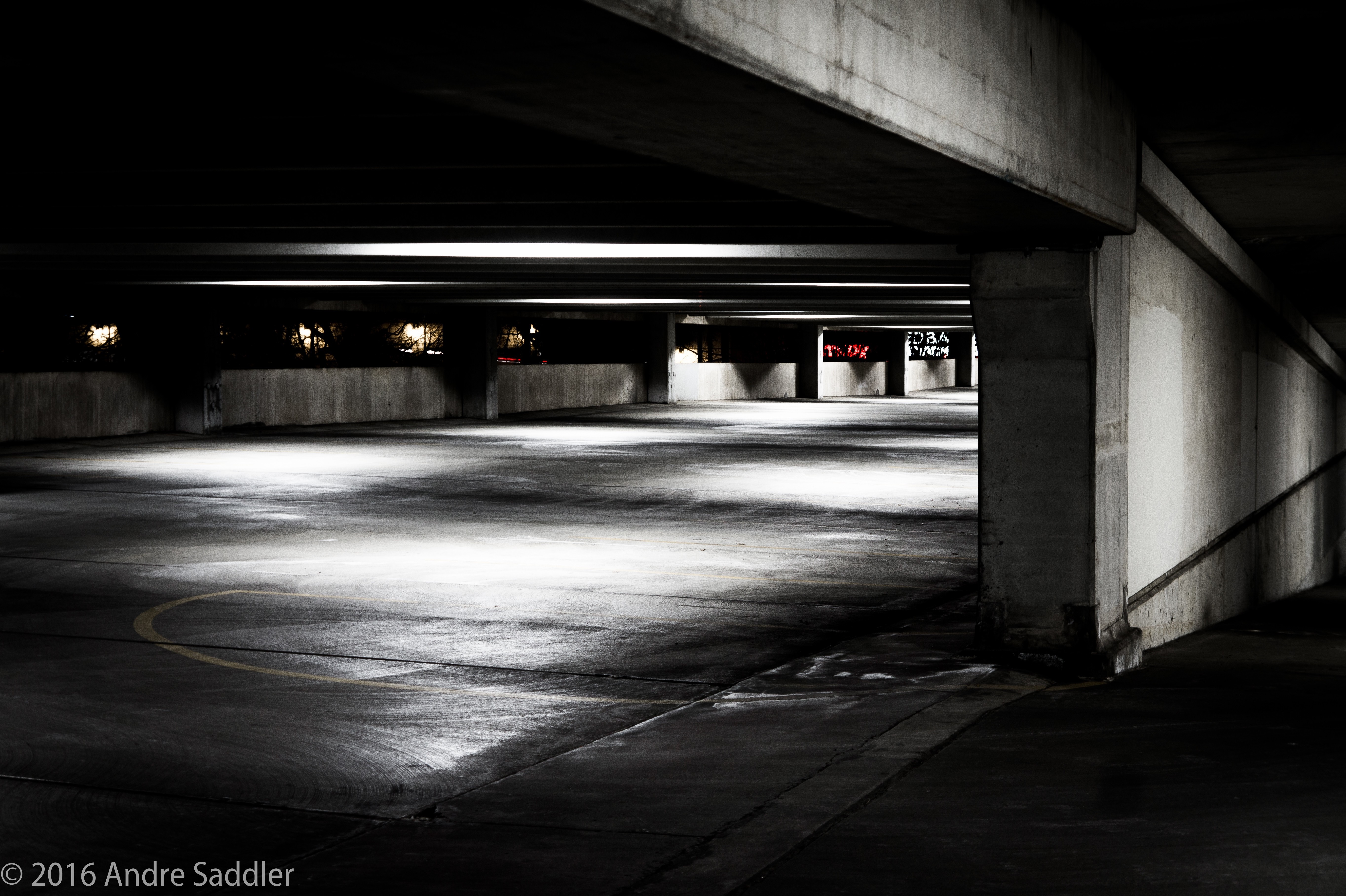 Empty parking garage at night with dramatic lighting HD Wallpaper