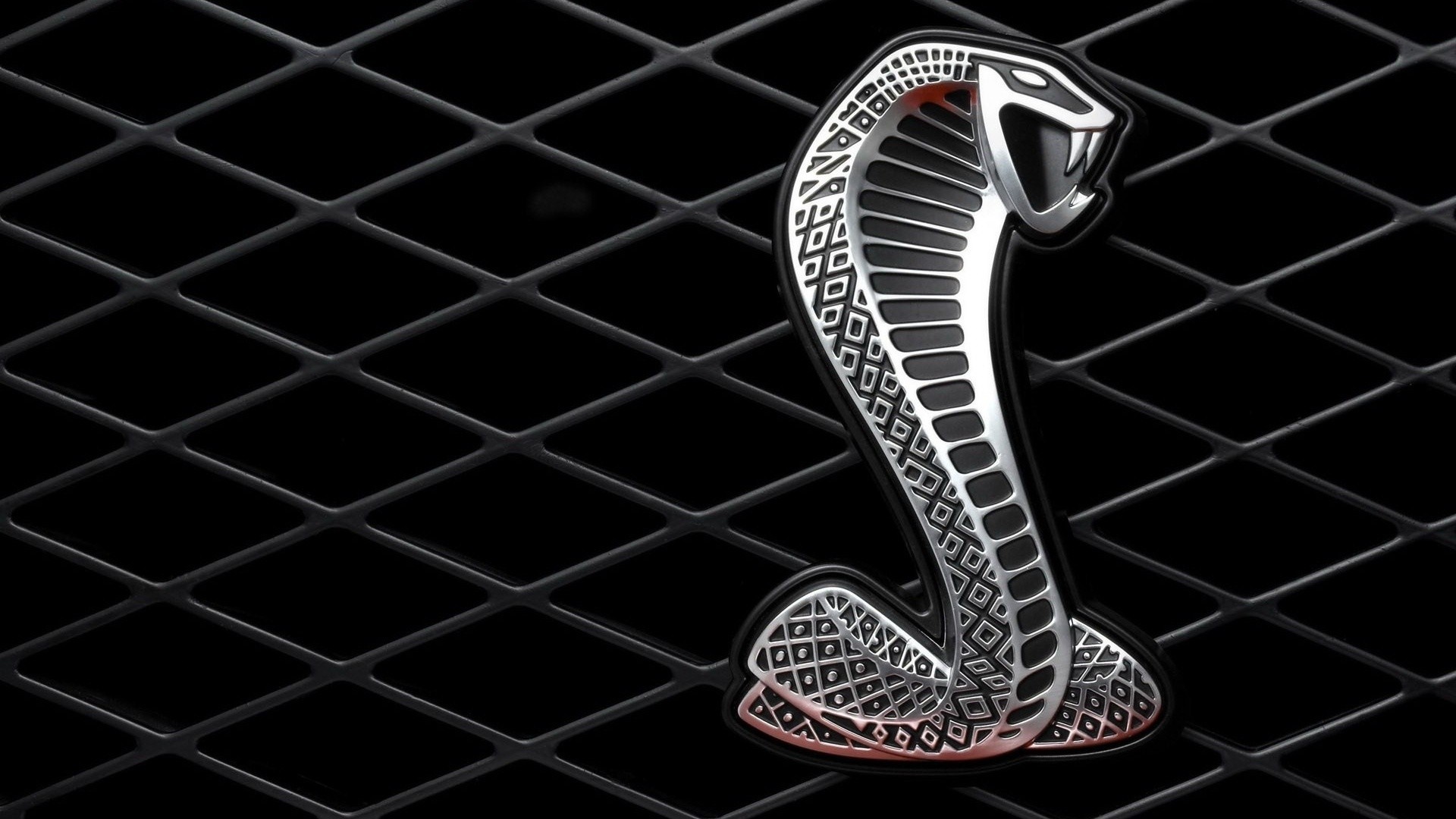 Ford Mustang Shelby Cobra emblem on a black grille HD Wallpaper