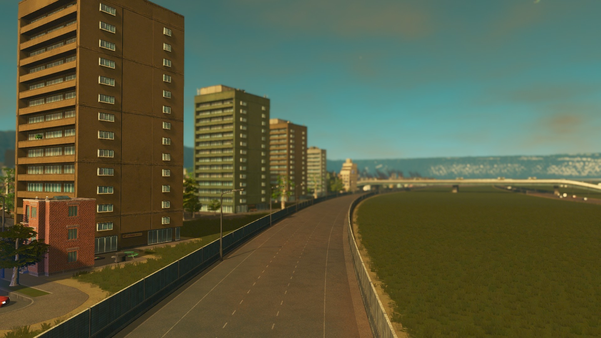 Cities Skylines cityscape with apartment buildings and highway HD Wallpaper