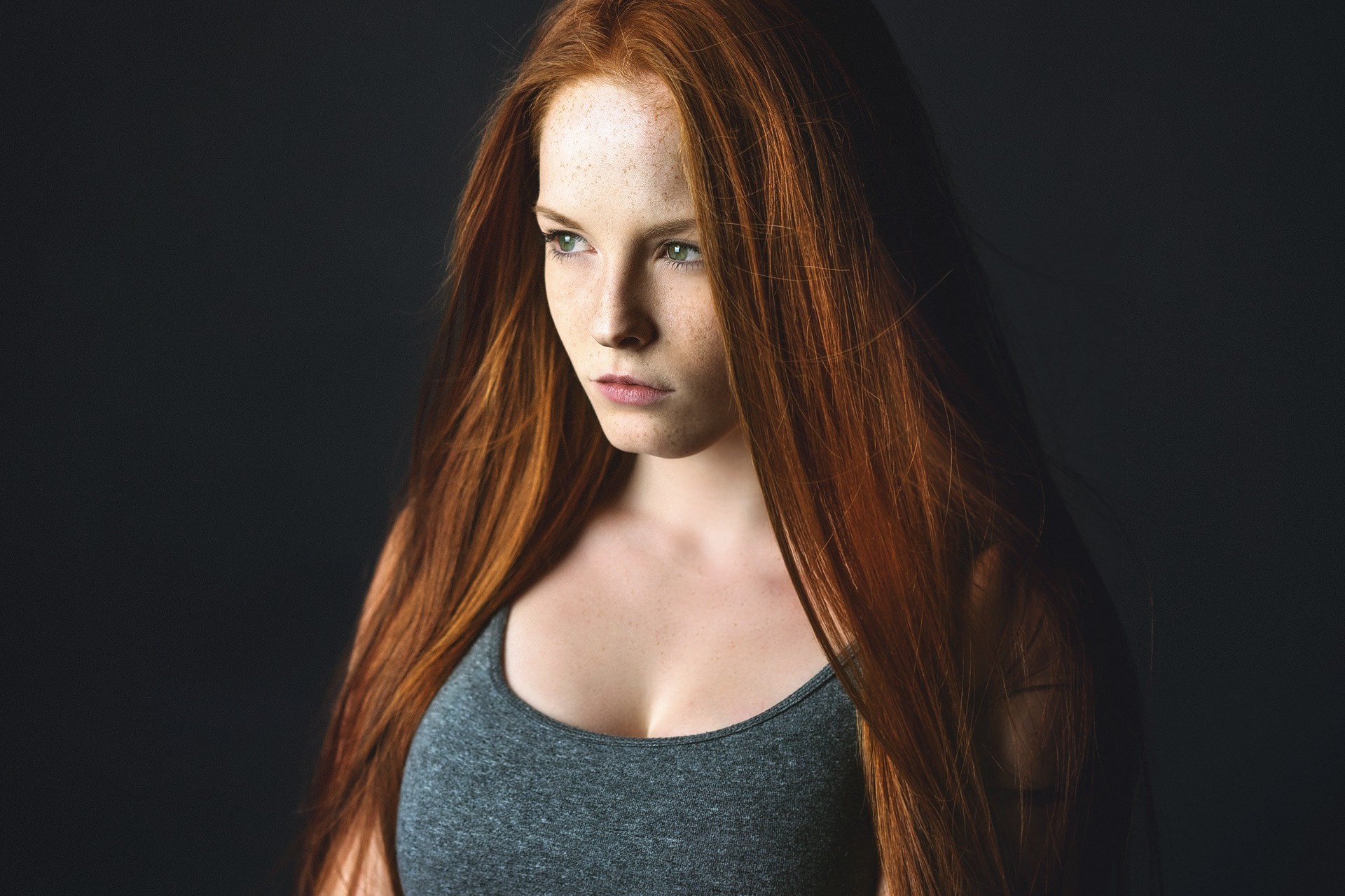 Portrait of a young woman with long red hair and freckles HD Wallpaper
