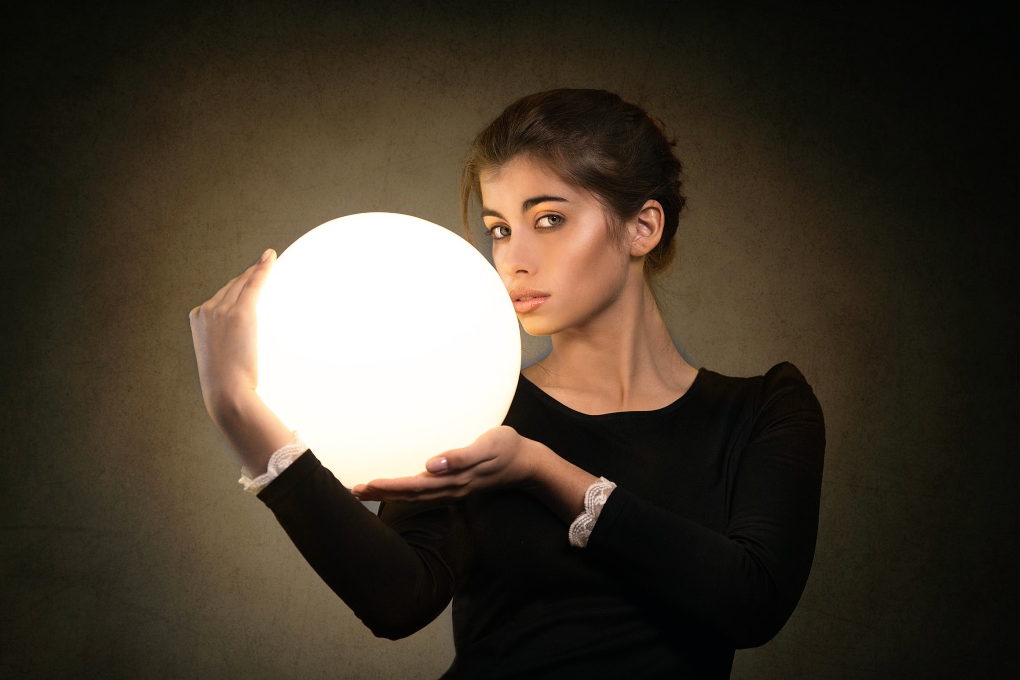 Woman holding a glowing orb HD Wallpaper