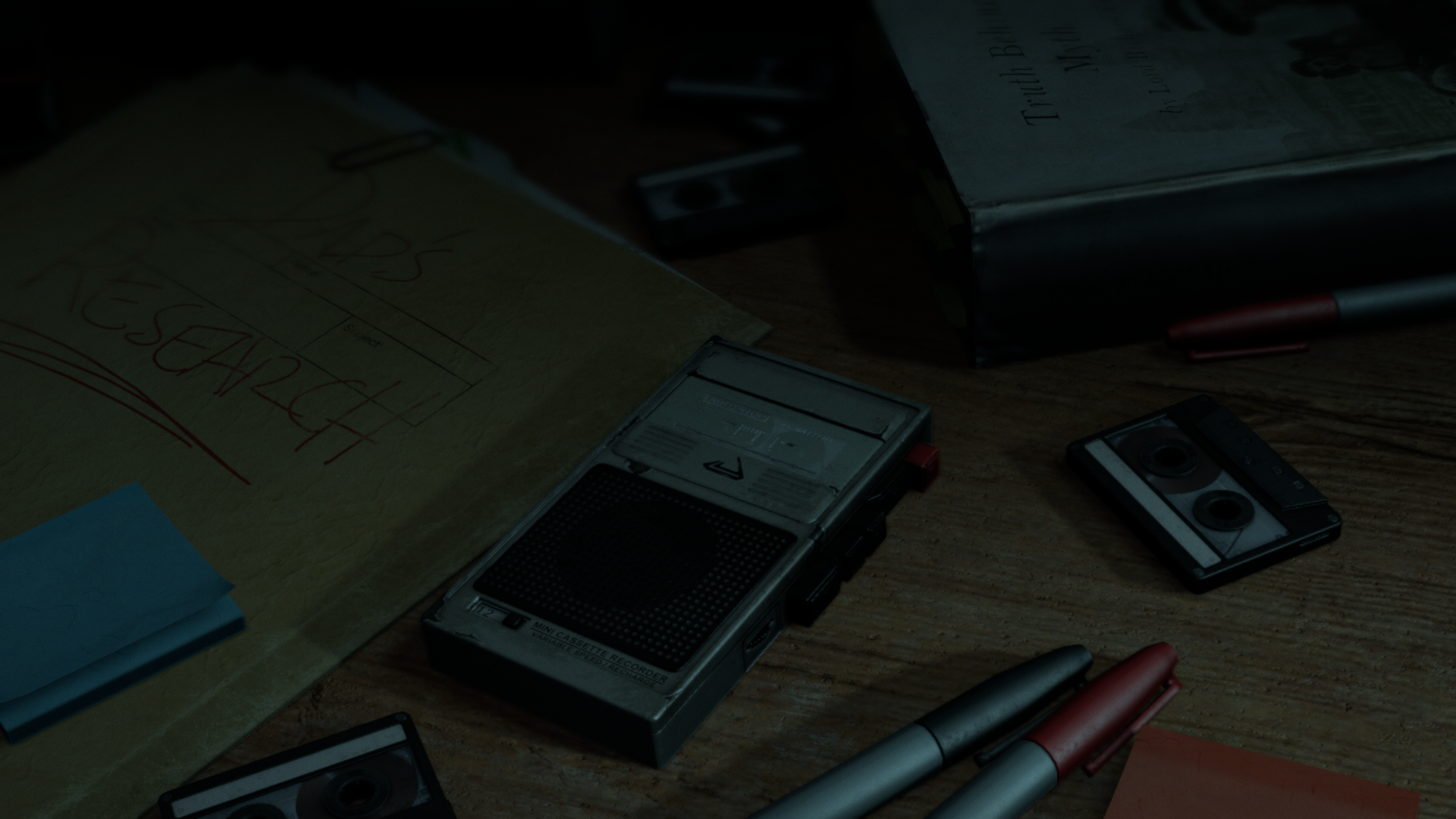 Research notes and audio recorder on a desk HD Wallpaper