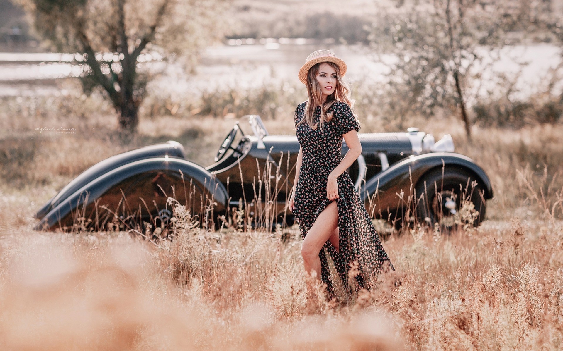 Woman in floral dress and hat by vintage car HD Wallpaper