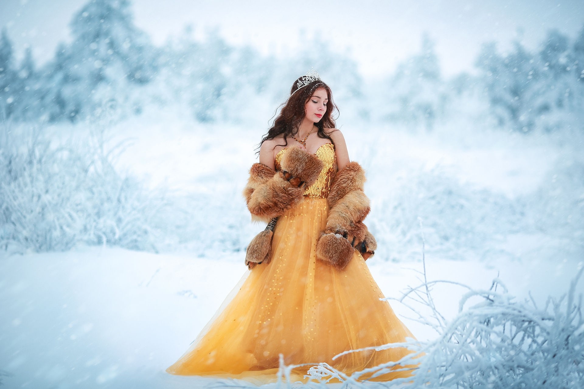 Woman in yellow dress and fur coat in snow HD Wallpaper