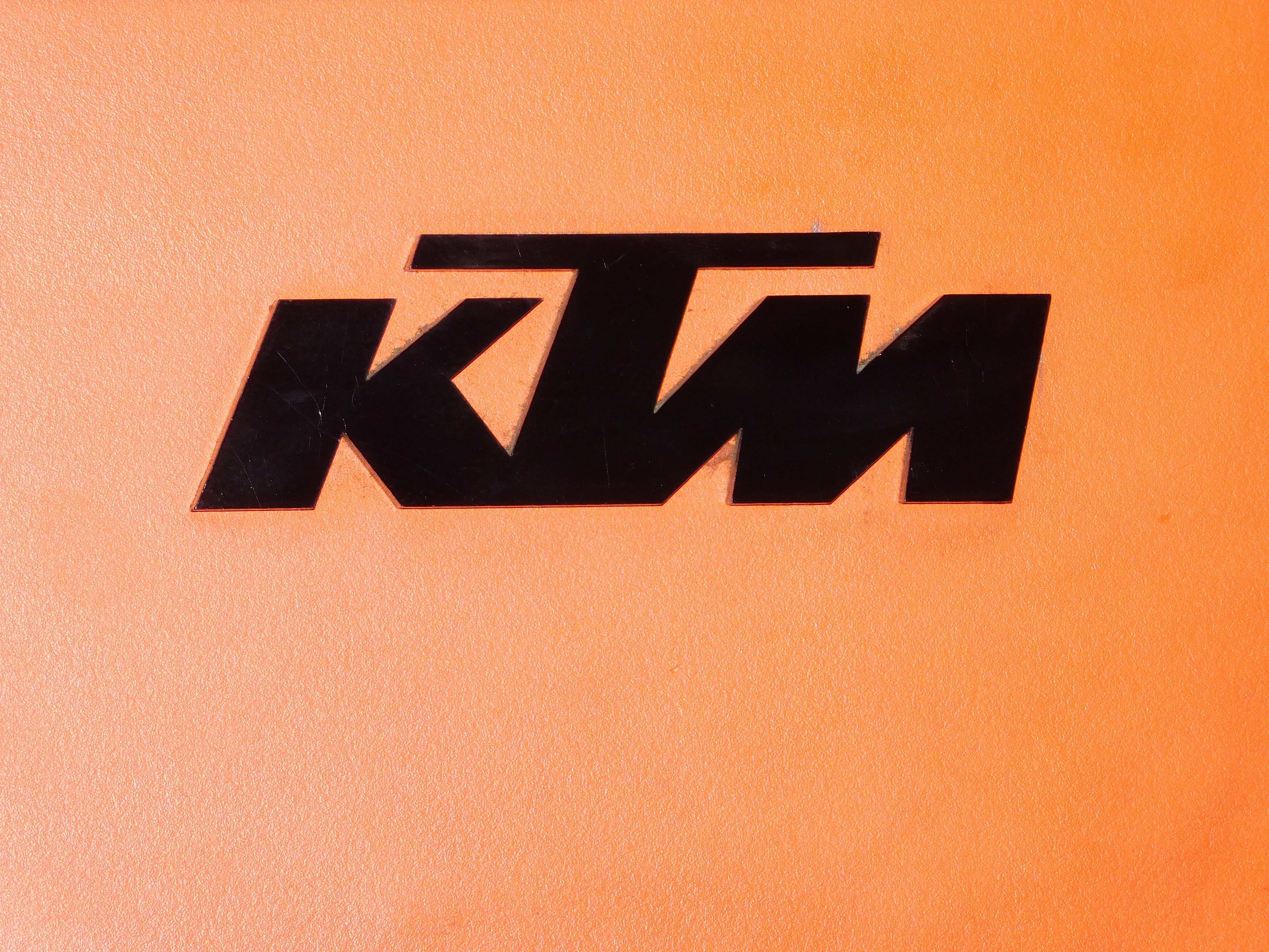KTM logo on orange background HD Wallpaper