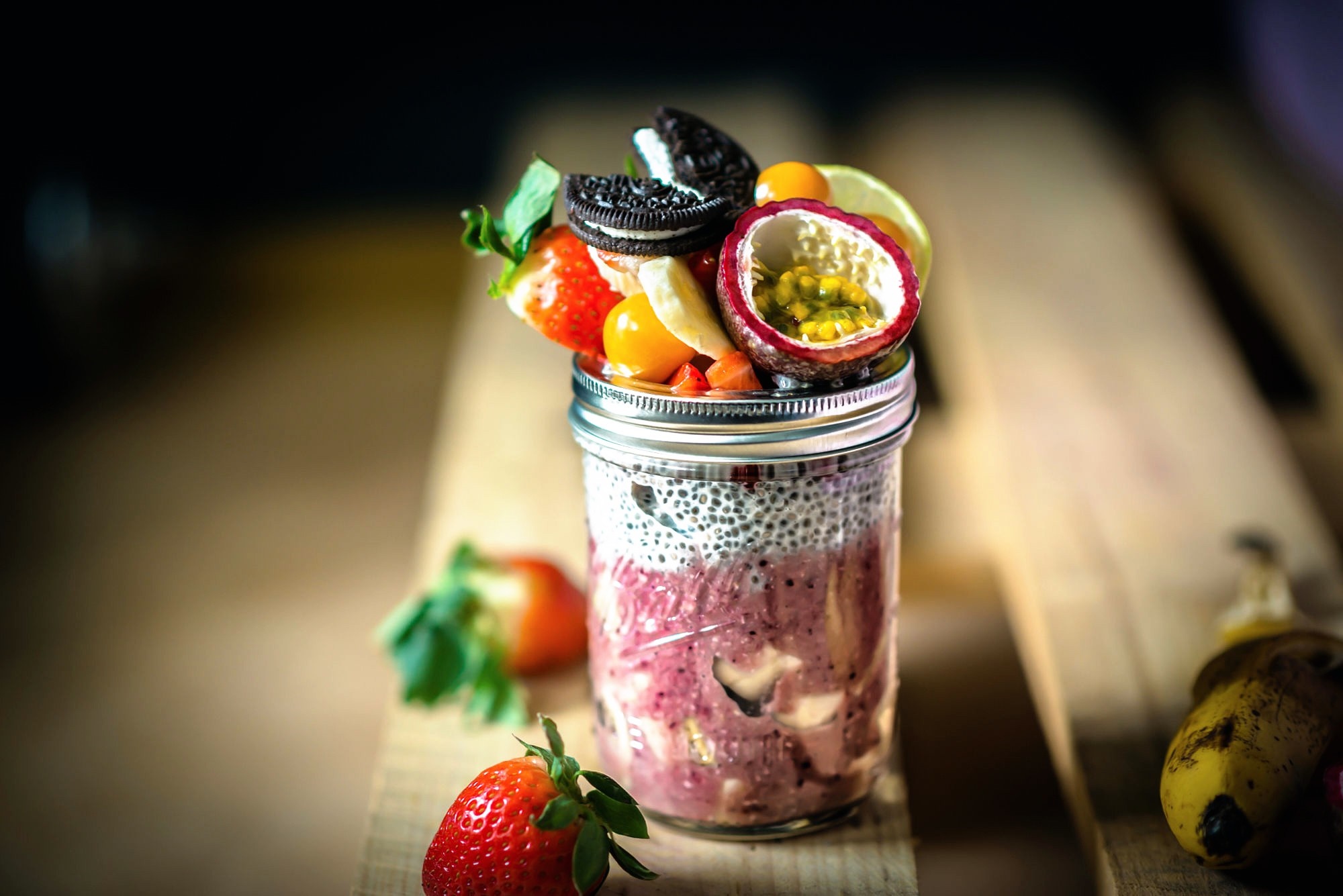 Jar of fruit parfait with strawberries and passion fruit HD Wallpaper