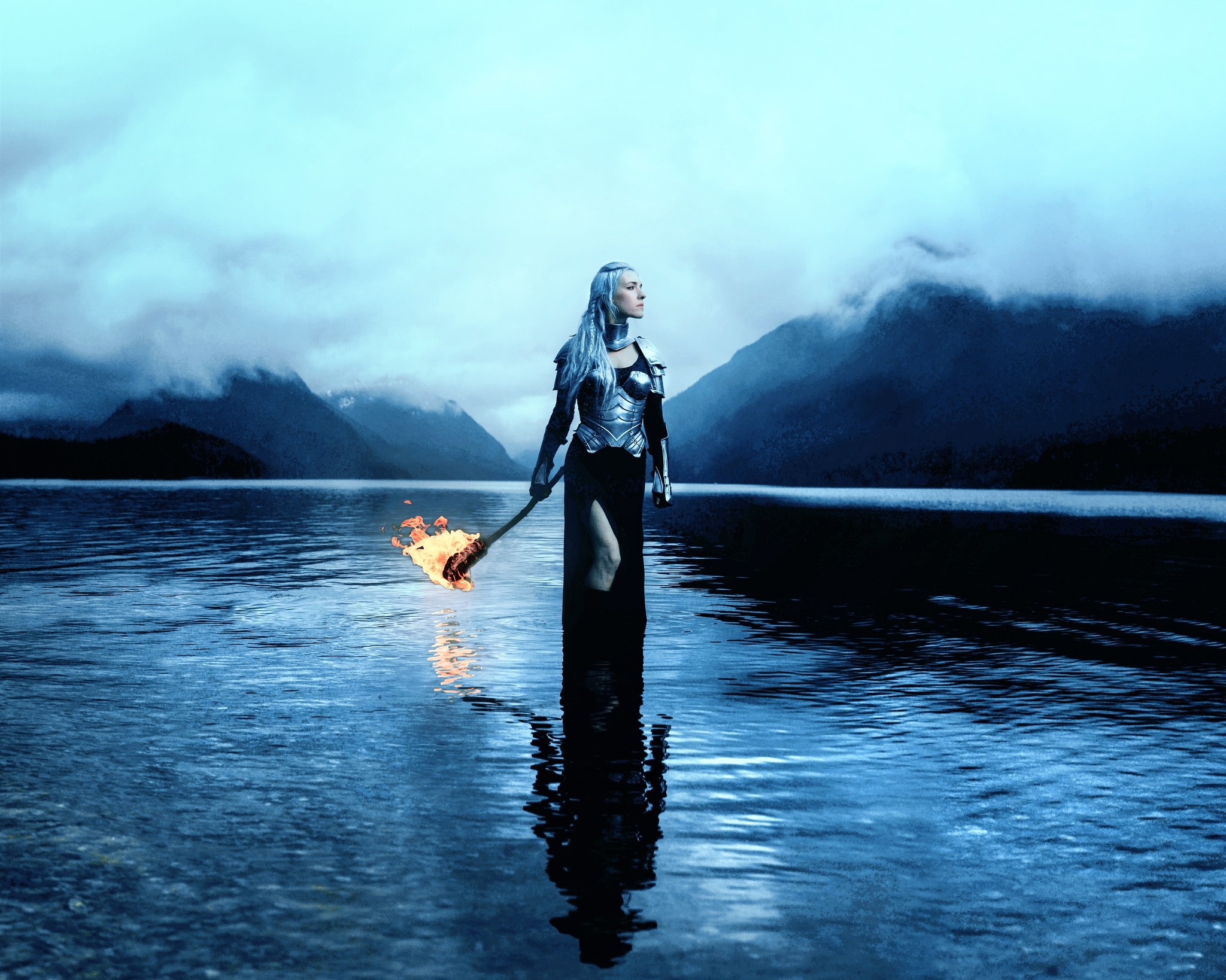 Woman with flaming torch in a lake HD Wallpaper