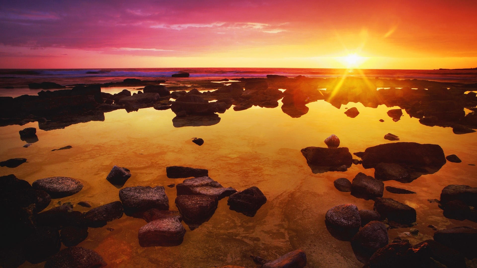 Sunset over the rocky coast with reflections HD Wallpaper