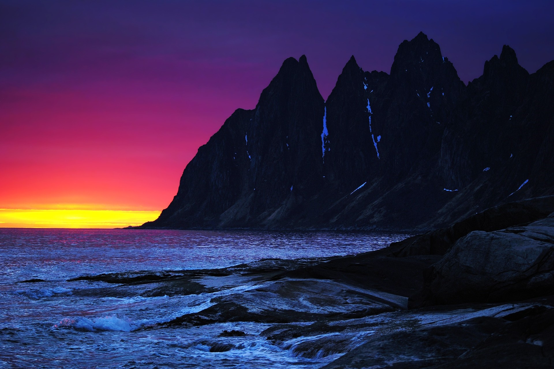Jagged mountains by the sea at sunset HD Wallpaper