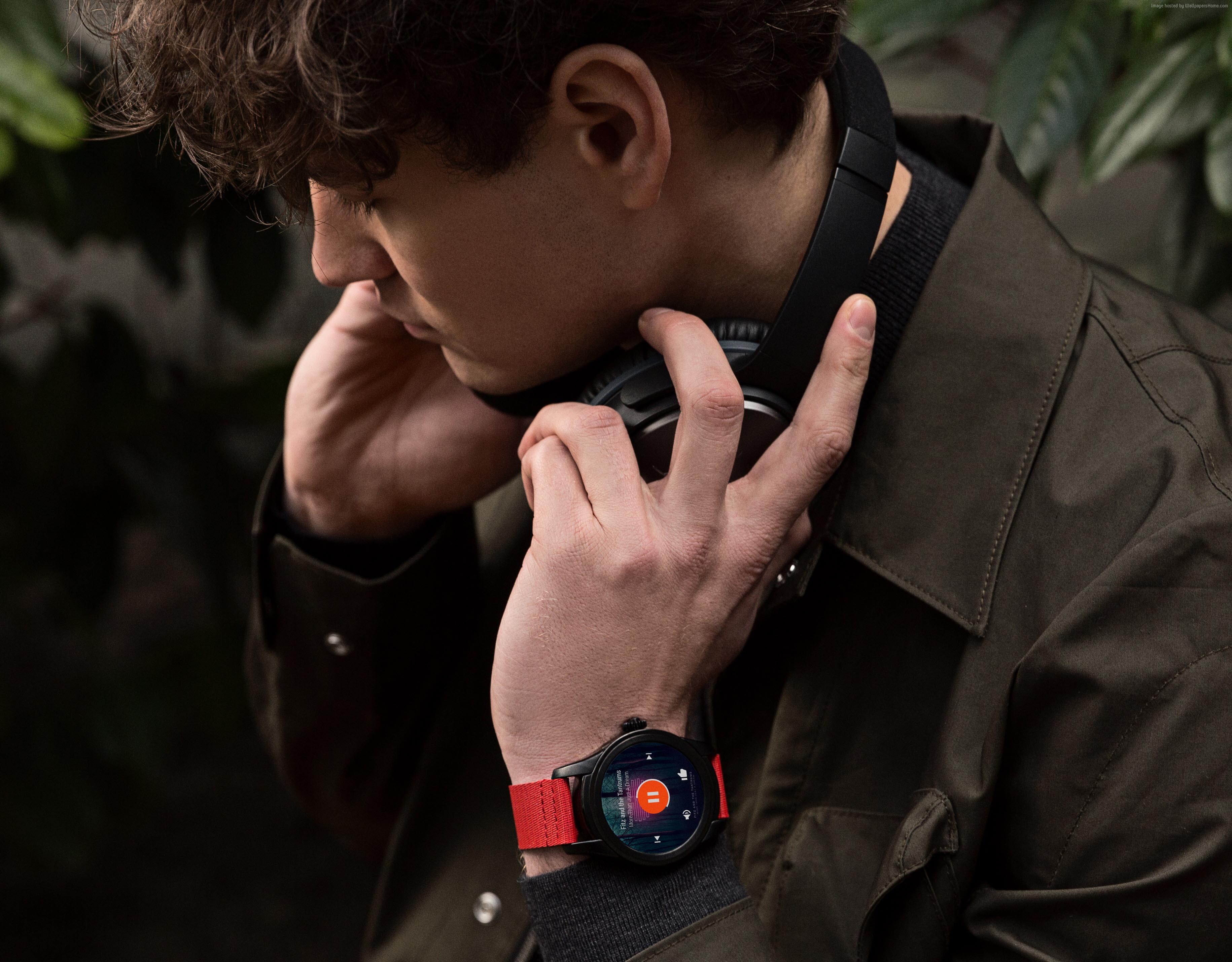 Man wearing Montblanc Summit smartwatch and headphones HD Wallpaper