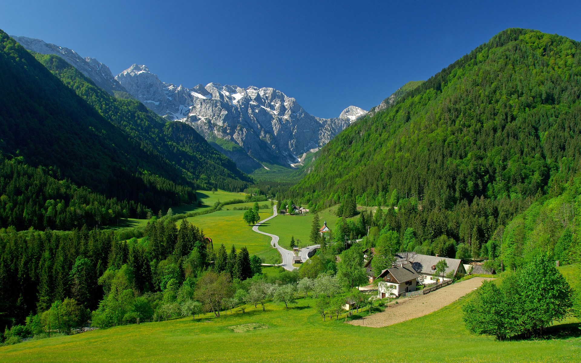 Green valley with mountains and houses HD Wallpaper