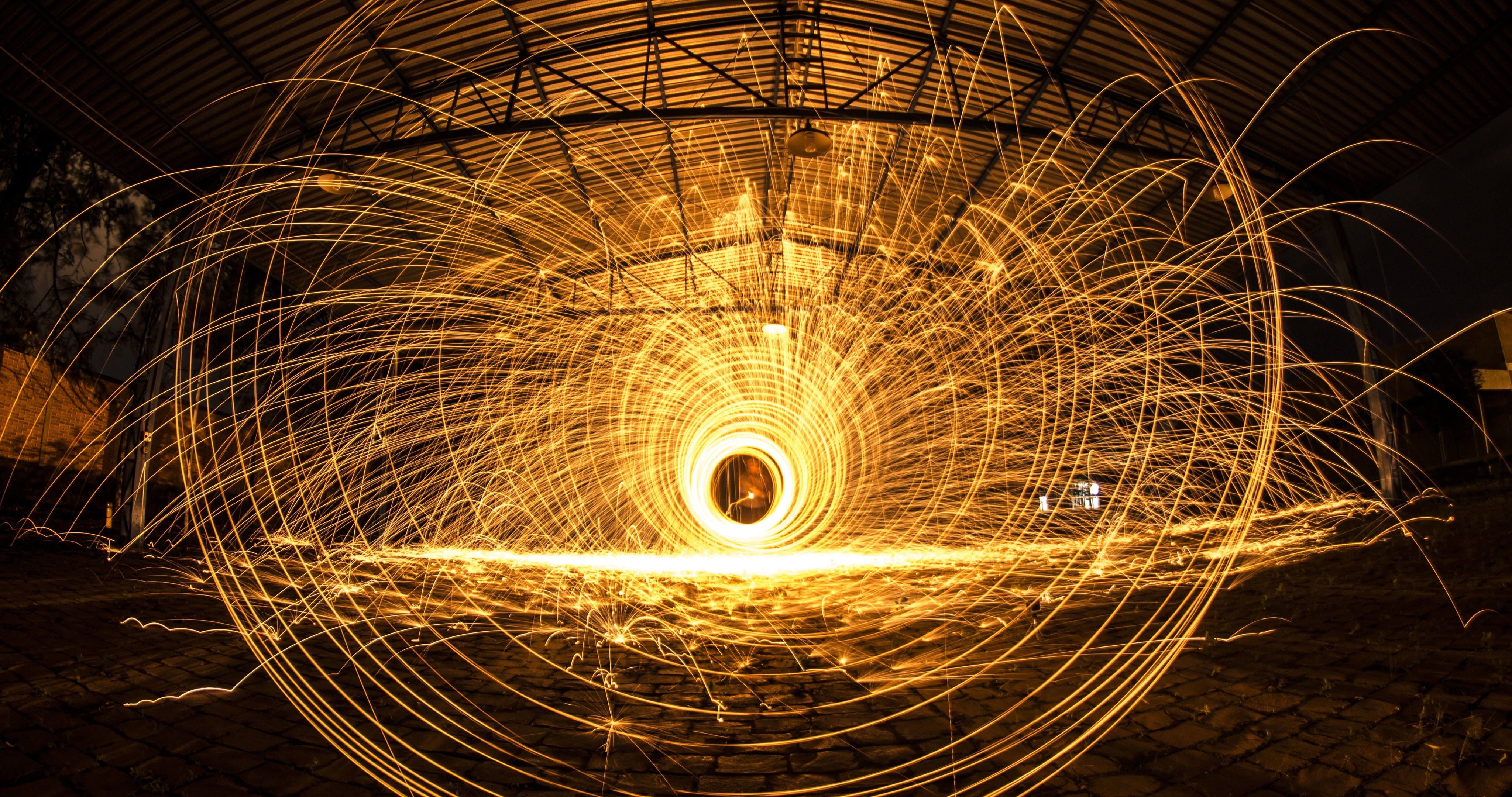 Long exposure light painting with sparks in a factory HD Wallpaper