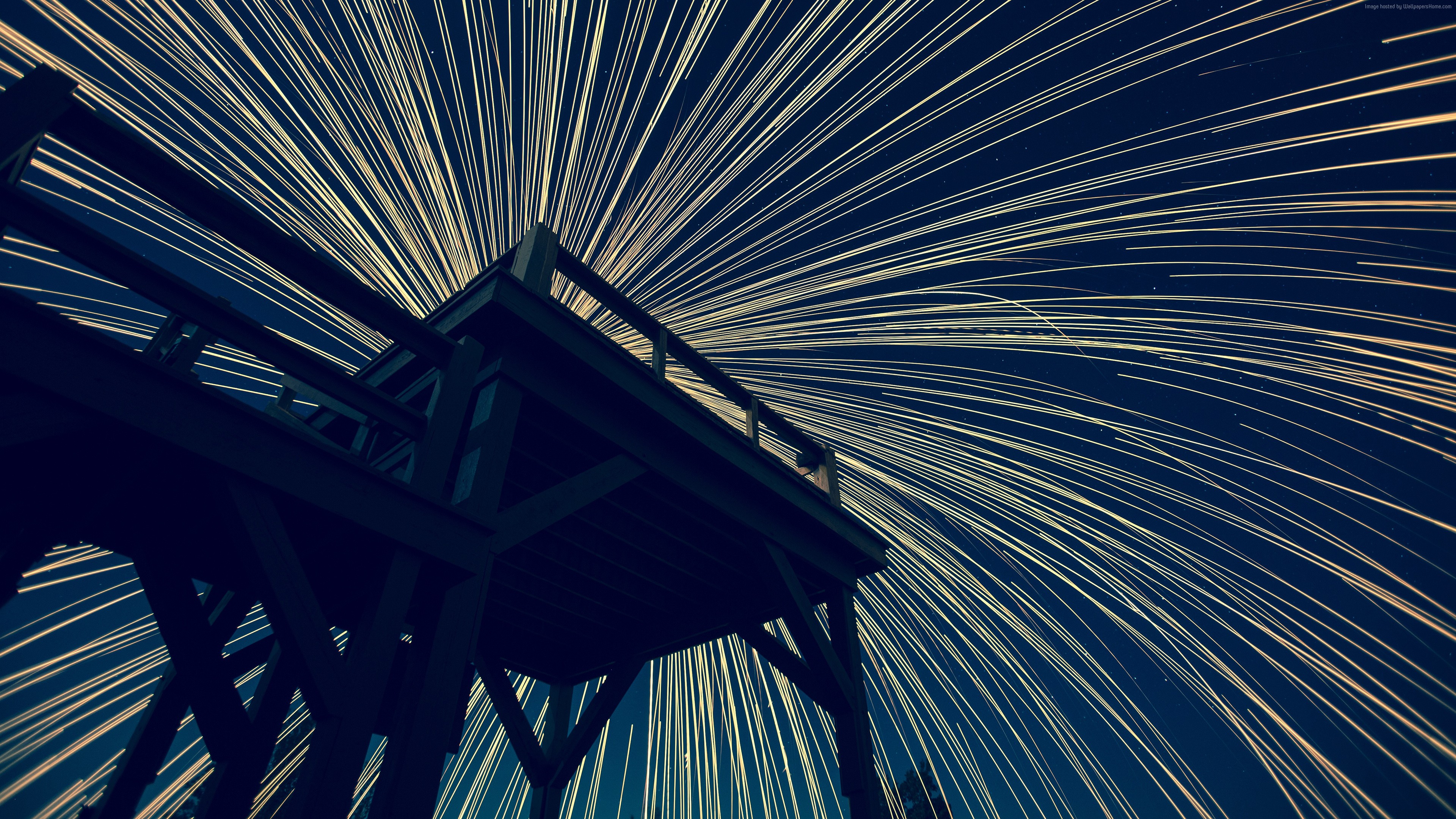 Wooden structure against a starry sky with light trails HD Wallpaper