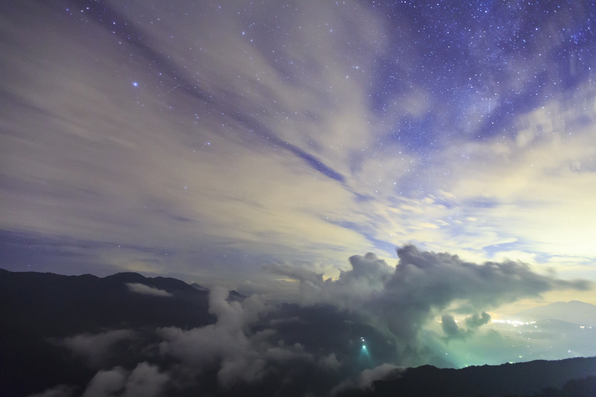 Night sky with stars and clouds over mountains HD Wallpaper