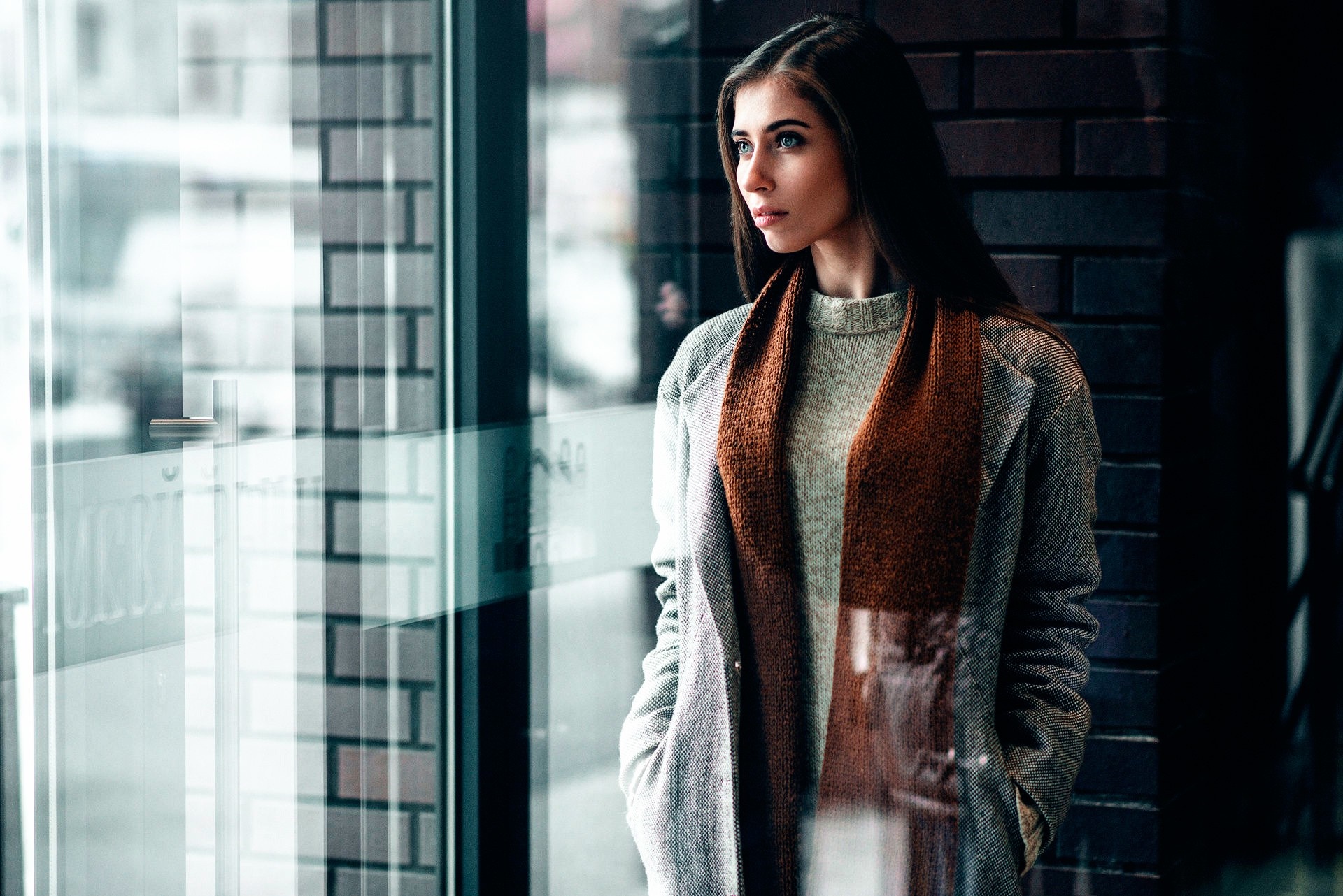 Woman in coat and scarf looking out window HD Wallpaper