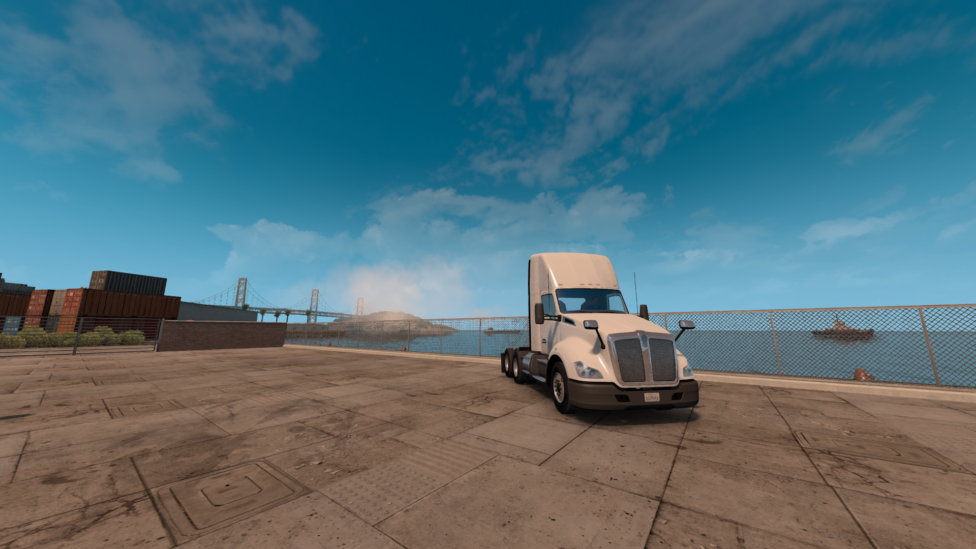 White semi-truck at a port with a bridge in the background HD Wallpaper