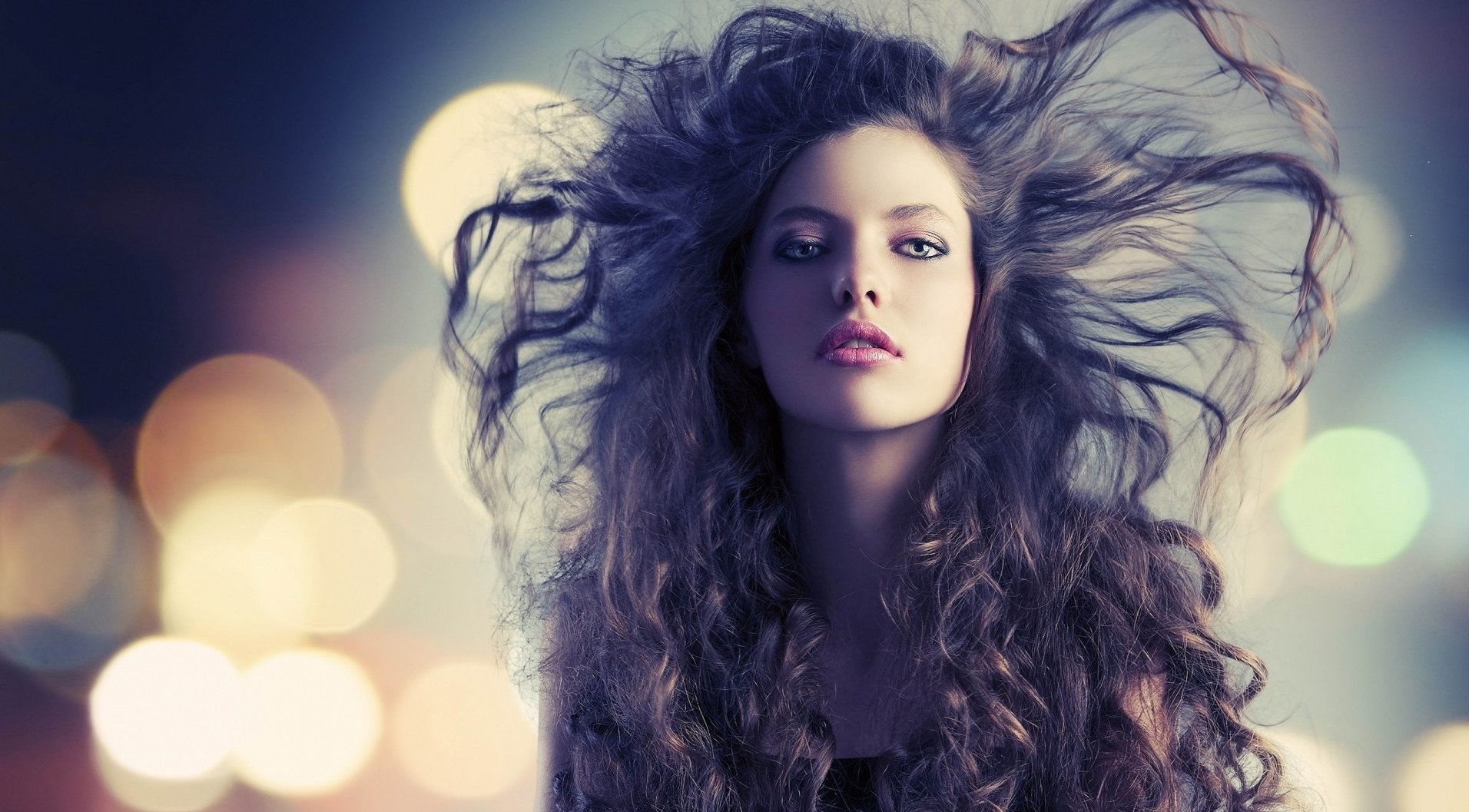 Woman with voluminous curly hair and bokeh background HD Wallpaper