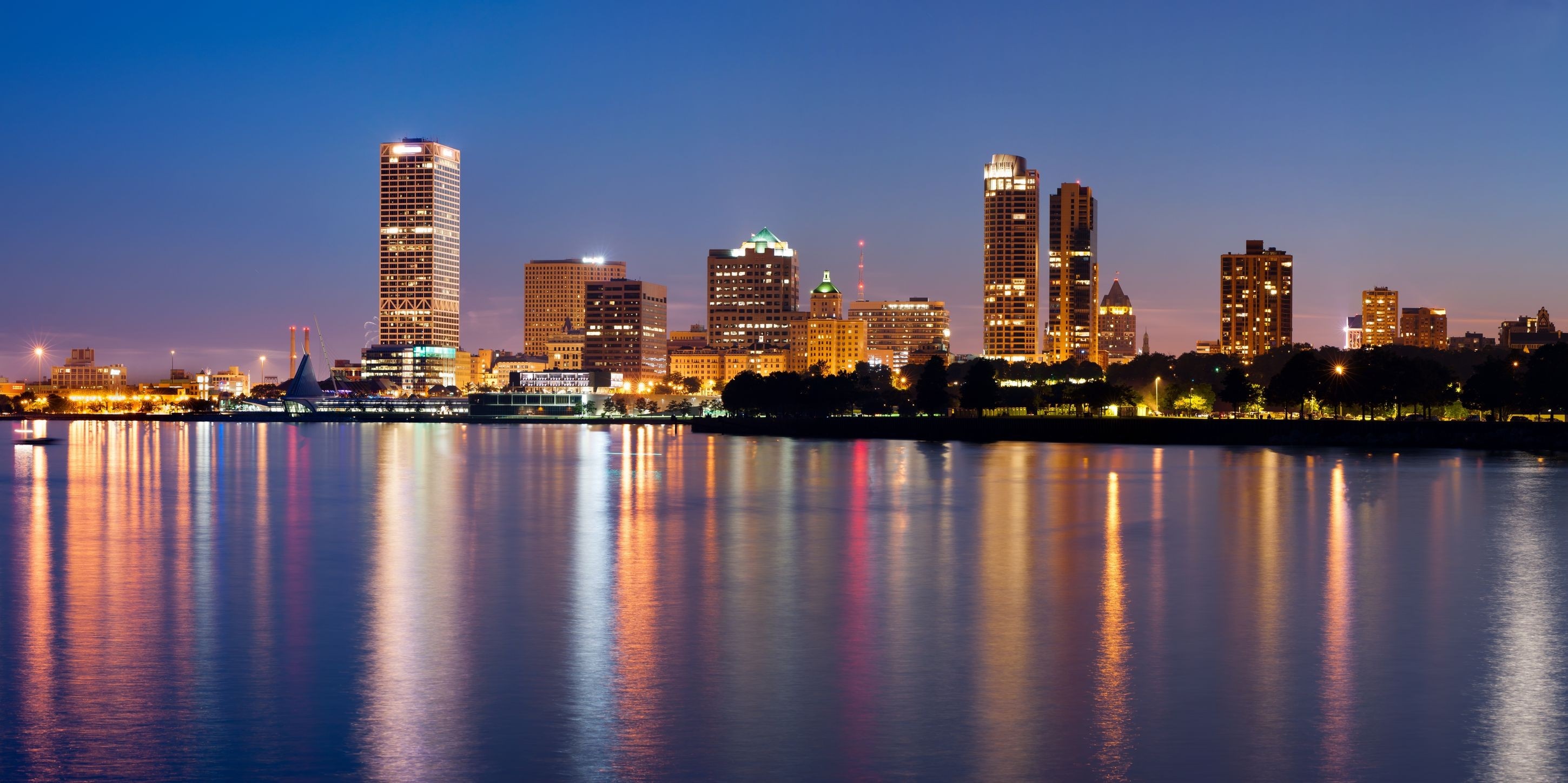 Milwaukee skyline at night with reflections on the water HD Wallpaper