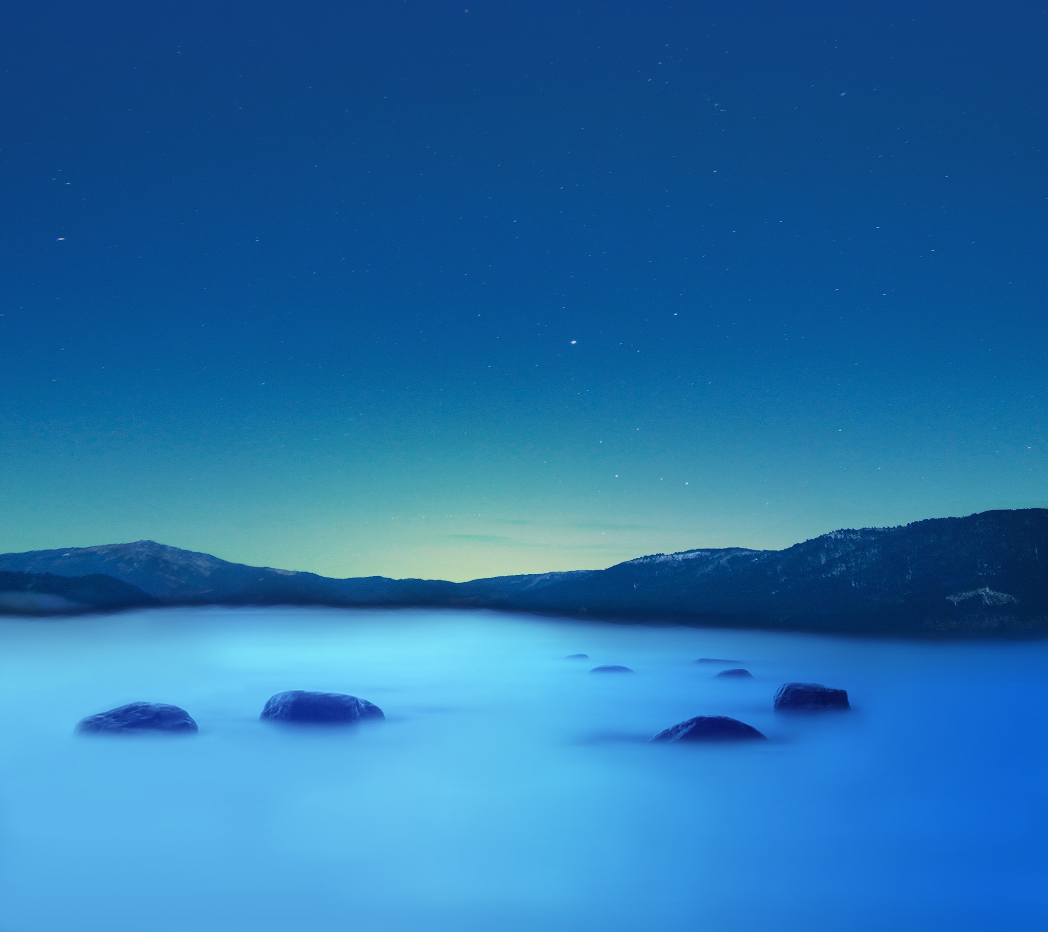 Rocks in foggy lake under starry night sky HD Wallpaper