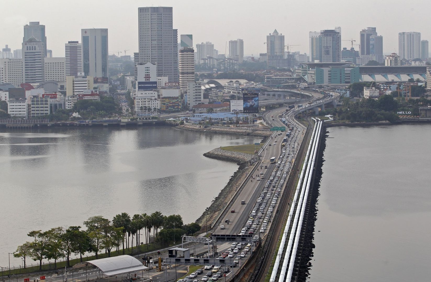 Cityscape with a busy highway bridge over water HD Wallpaper