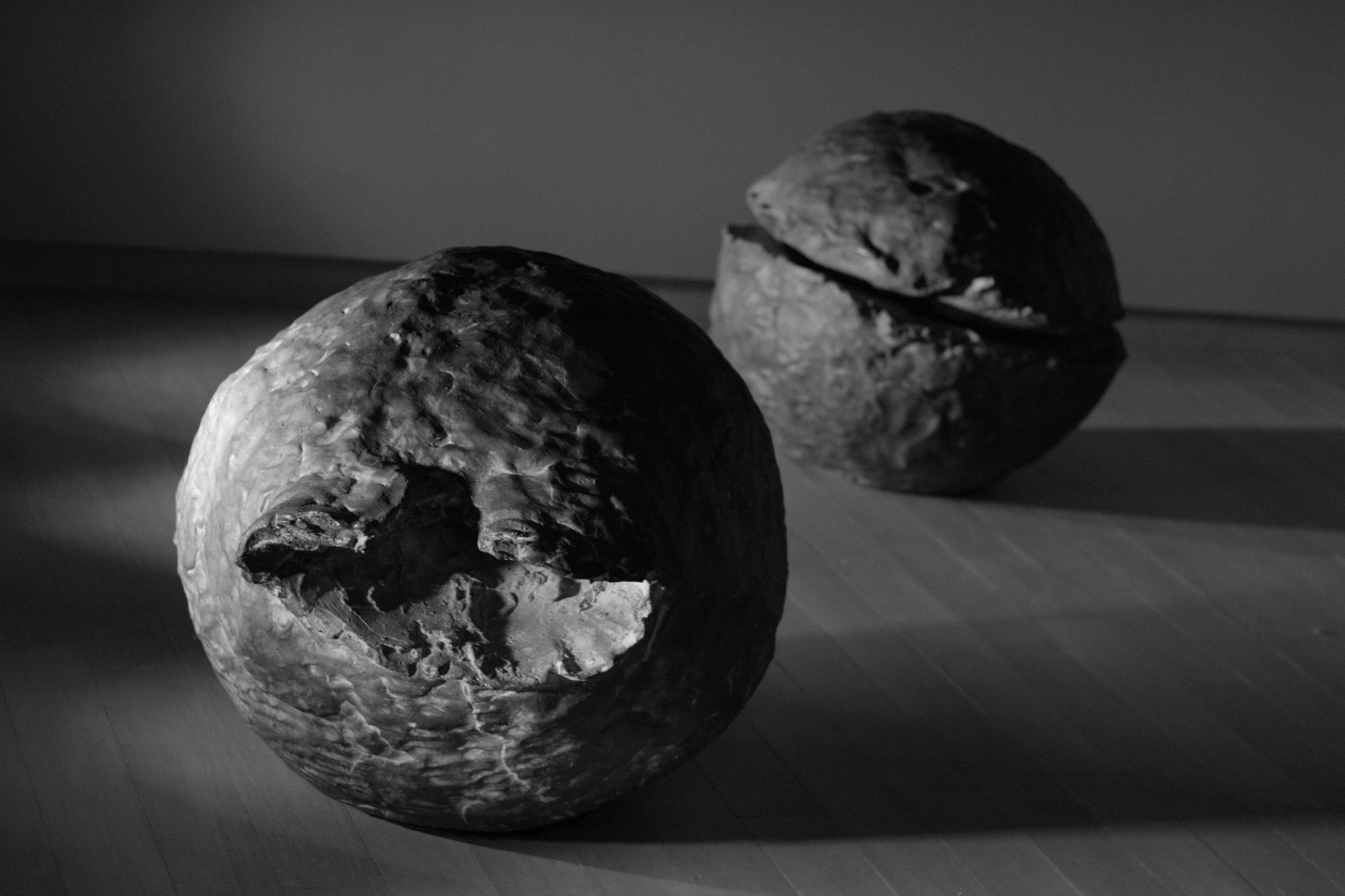 Two textured spheres on a wooden floor HD Wallpaper