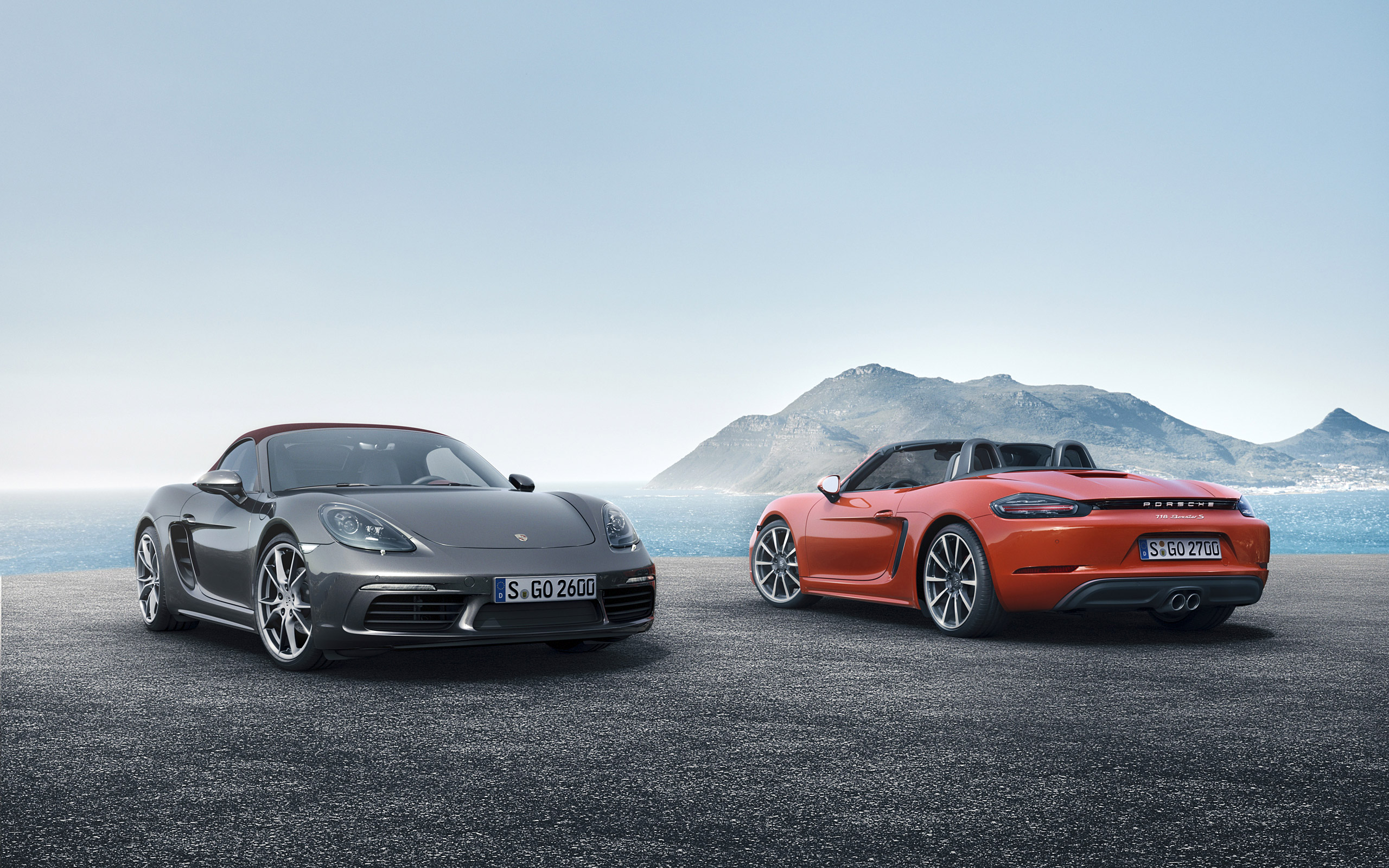 Two Porsche Boxster convertibles parked by the sea HD Wallpaper