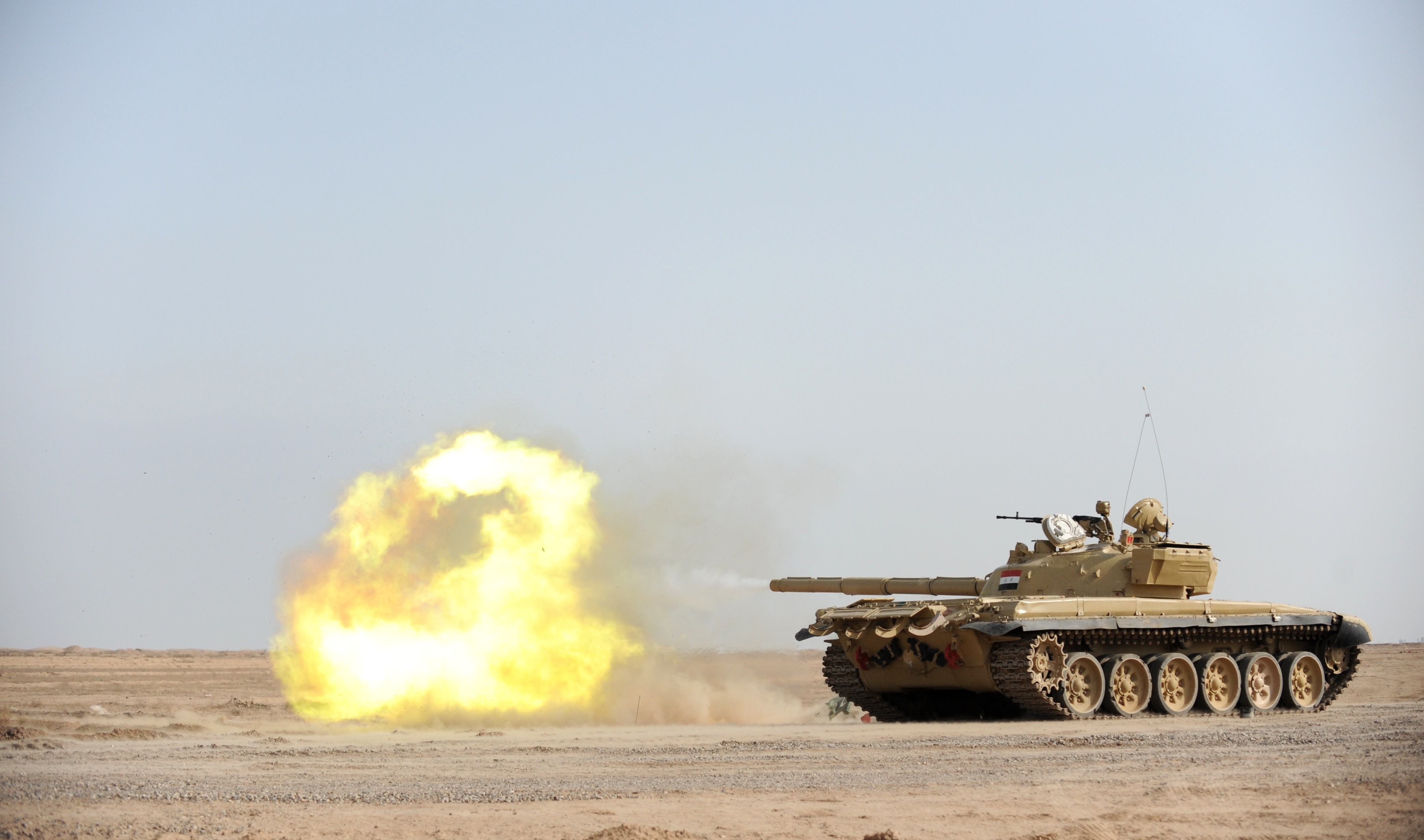 T-72 tank firing in a desert HD Wallpaper
