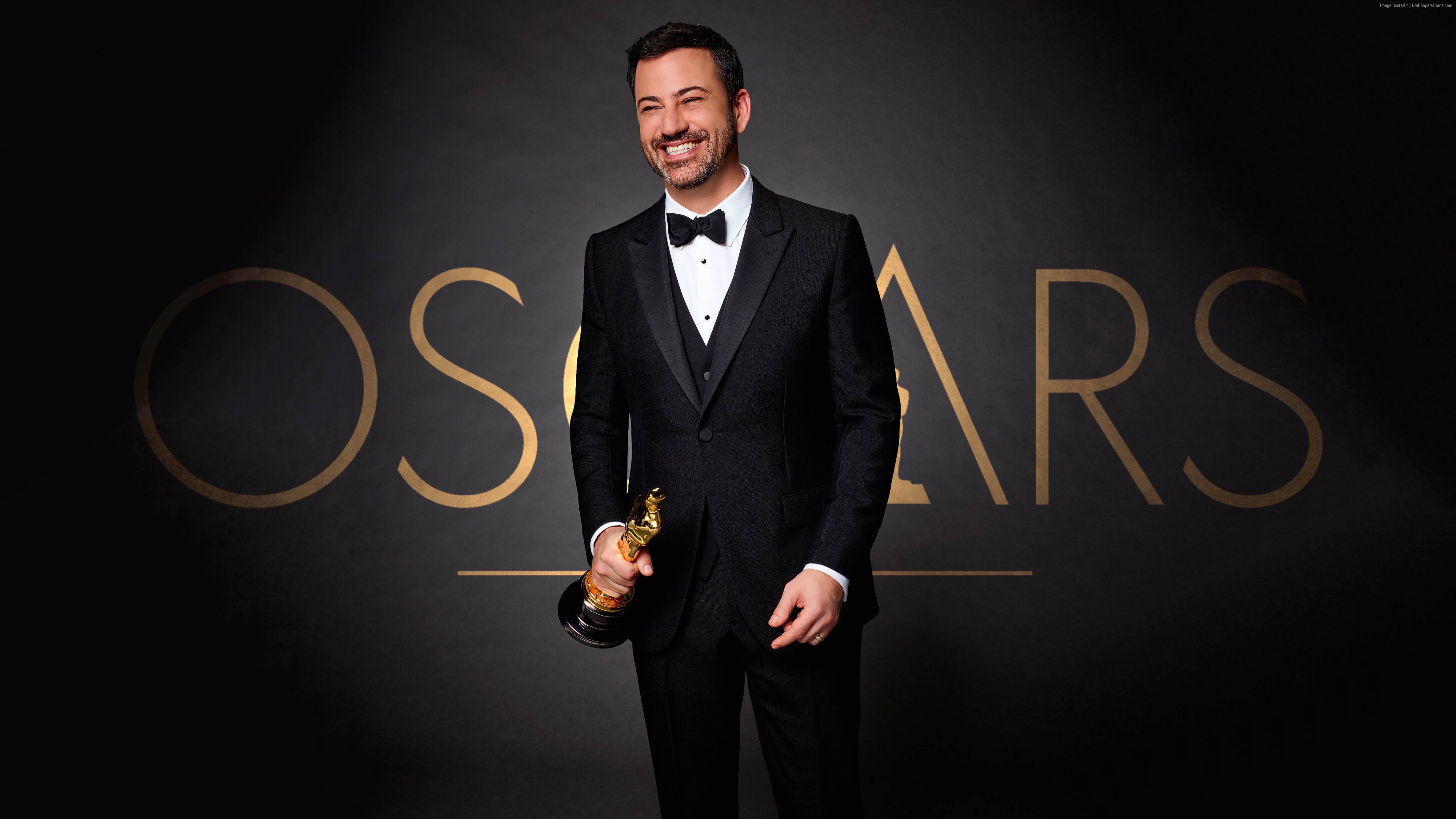 Jimmy Kimmel holding an Oscar award HD Wallpaper