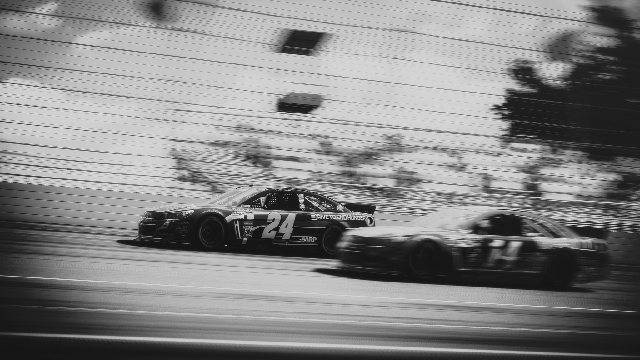 Two Nascar race cars on a track, motion blur HD Wallpaper