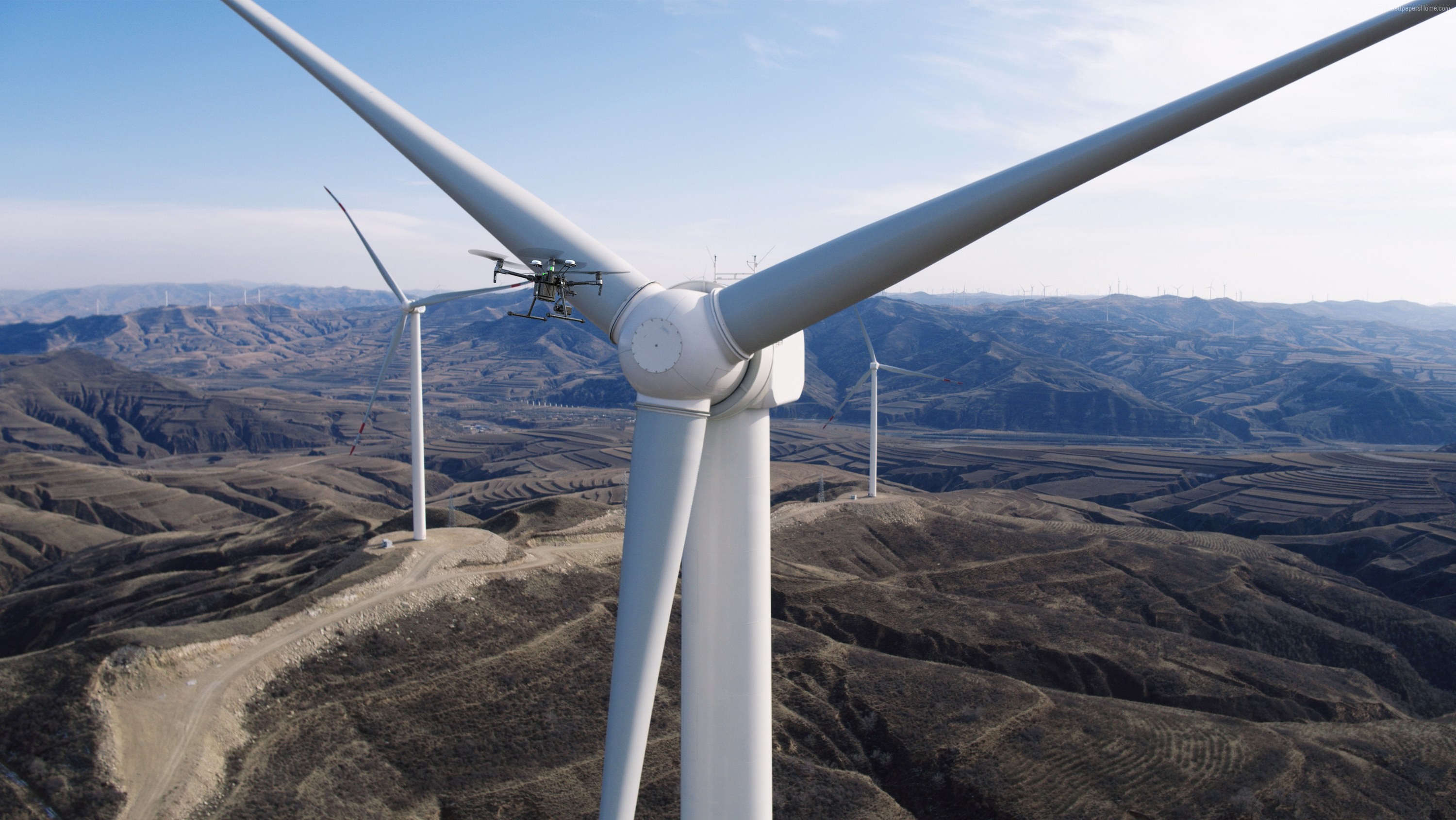 Drone inspecting a wind turbine HD Wallpaper