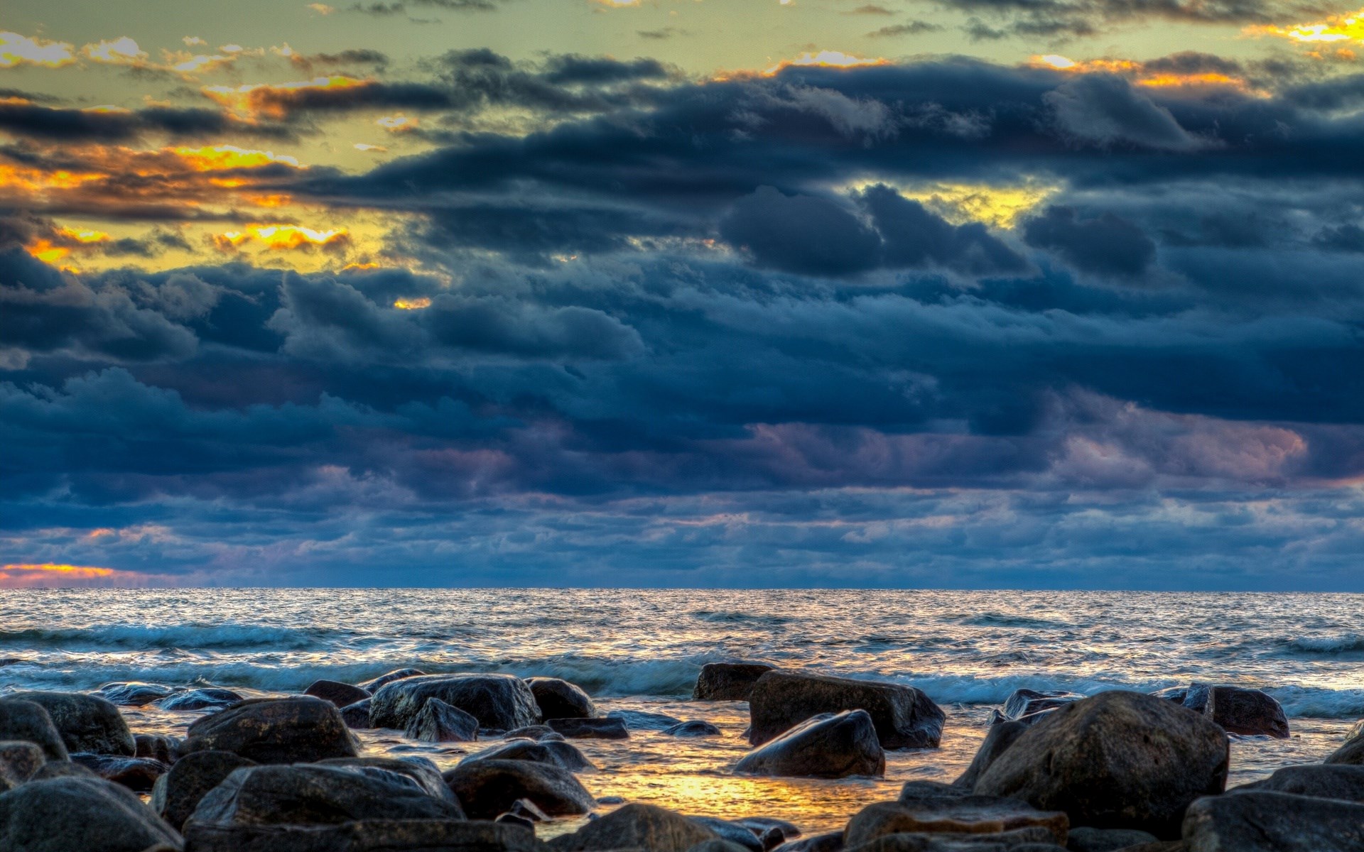 Stormy sunset over rocky shore HD Wallpaper