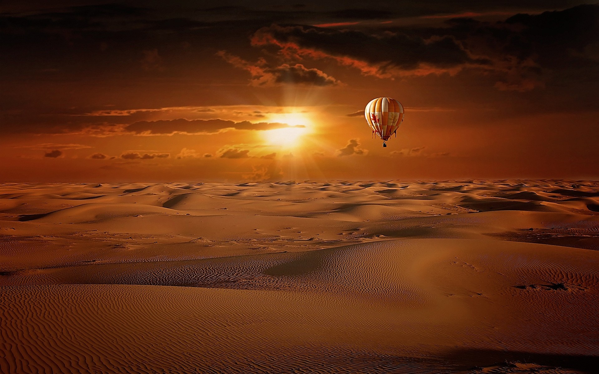 Hot air balloon over desert dunes at sunset HD Wallpaper