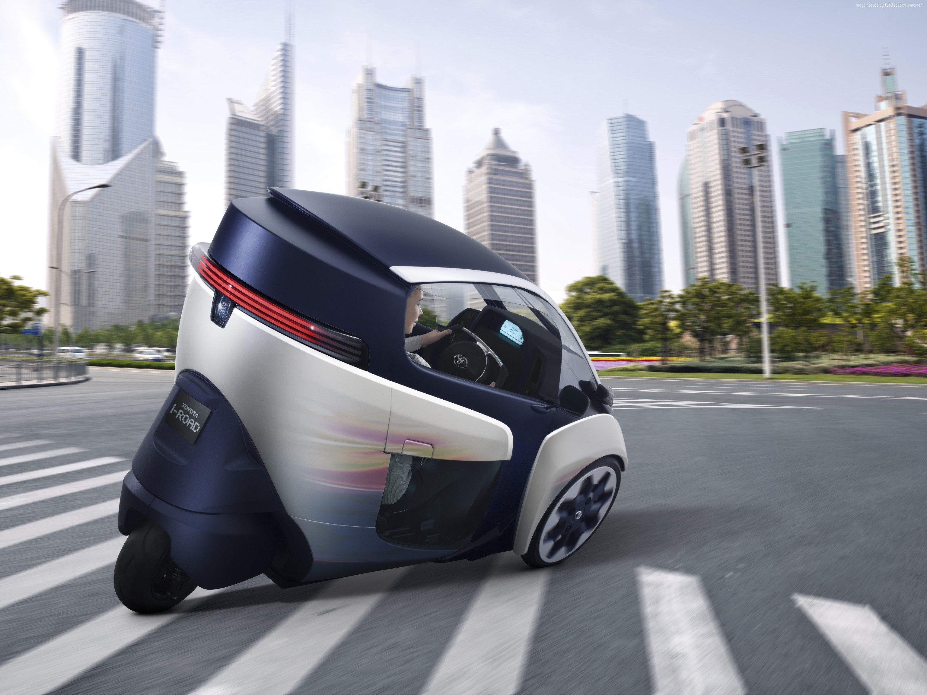 Toyota i-Road electric car driving in city HD Wallpaper