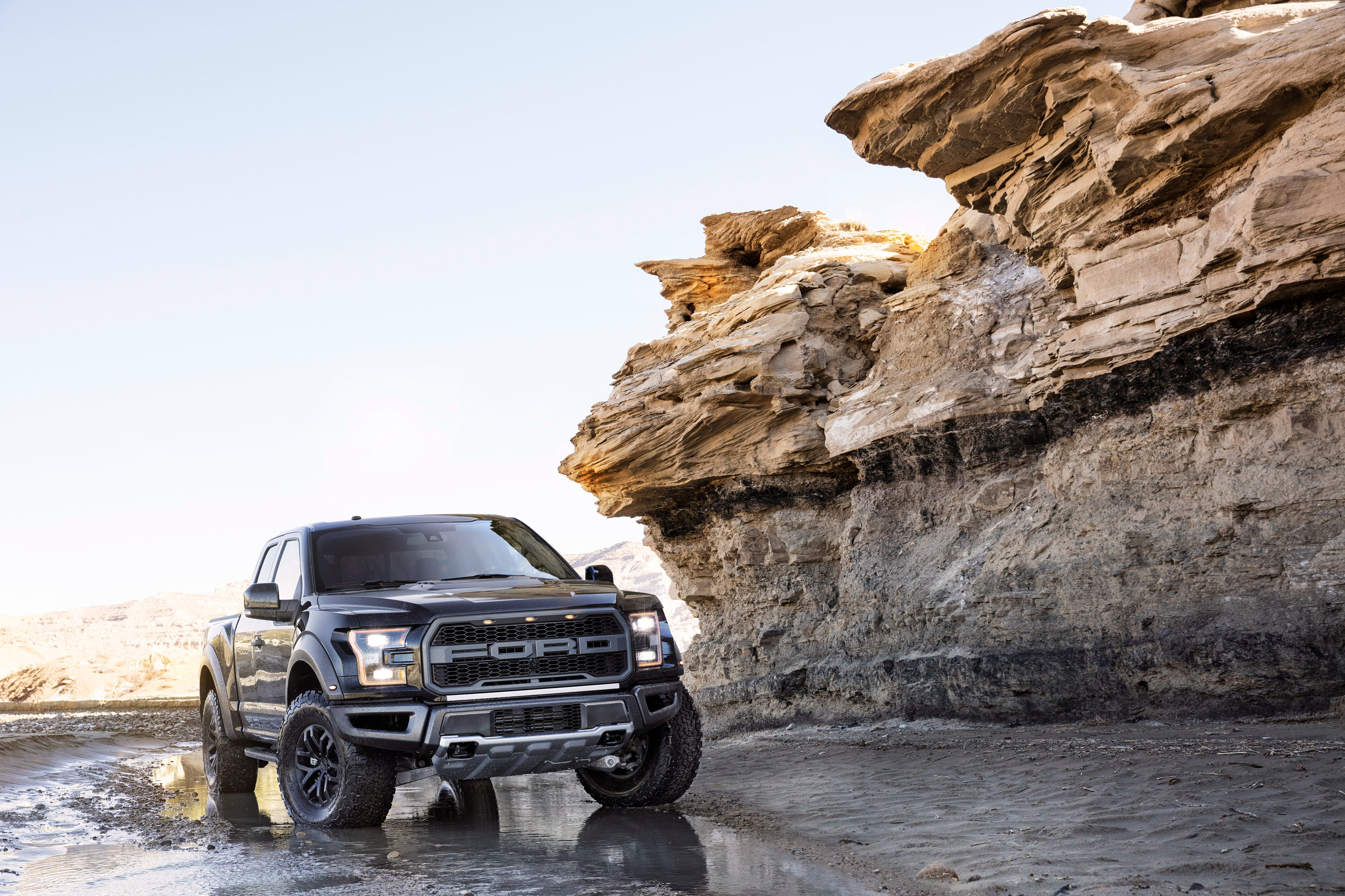 Black Ford F-150 Raptor in a Rocky, Arid Landscape HD Wallpaper
