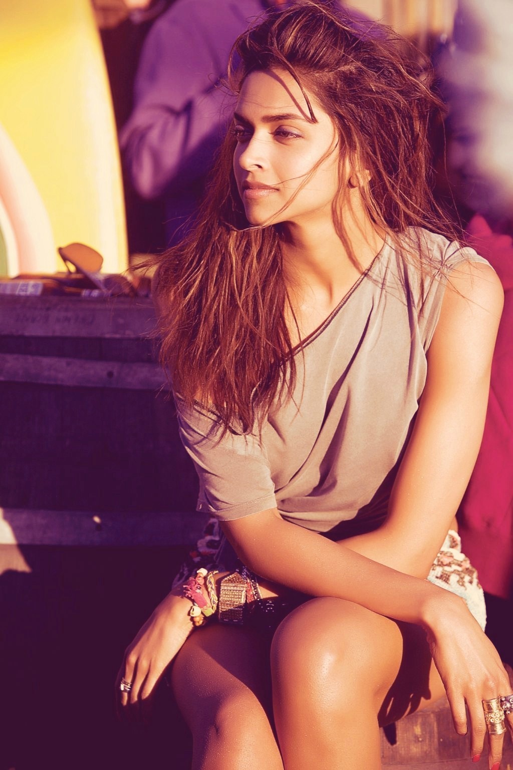 Deepika Padukone sitting outdoors with surfboards HD Wallpaper