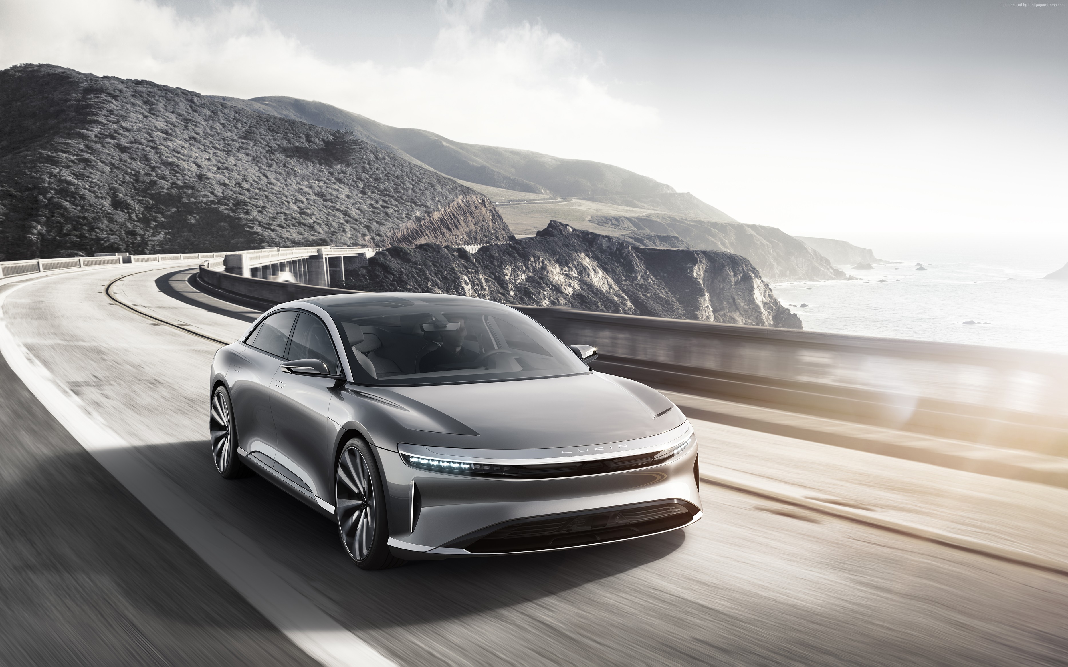 Lucid Air electric car driving on coastal highway HD Wallpaper