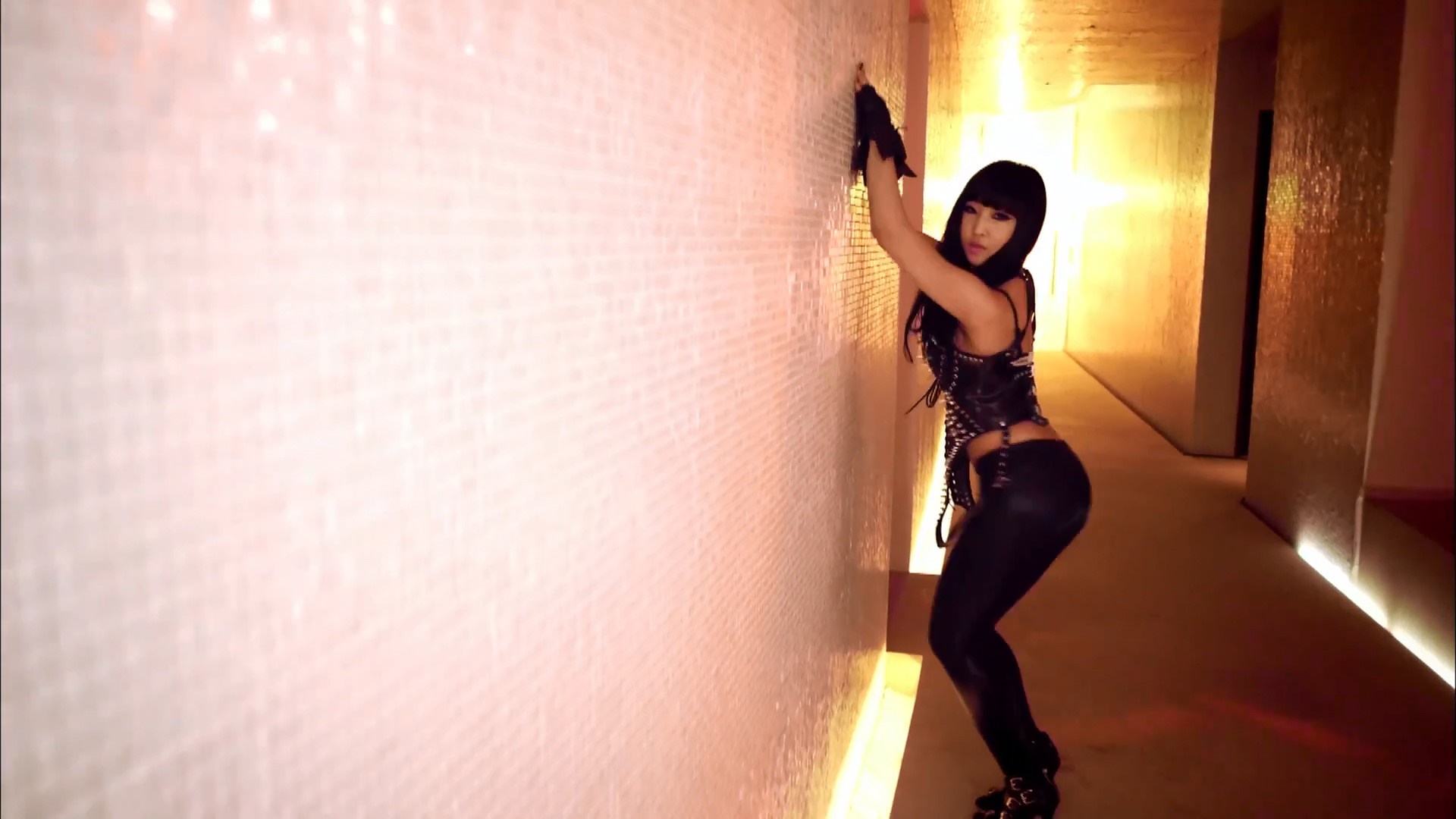 Minzy from 2NE1 posing against a textured wall HD Wallpaper